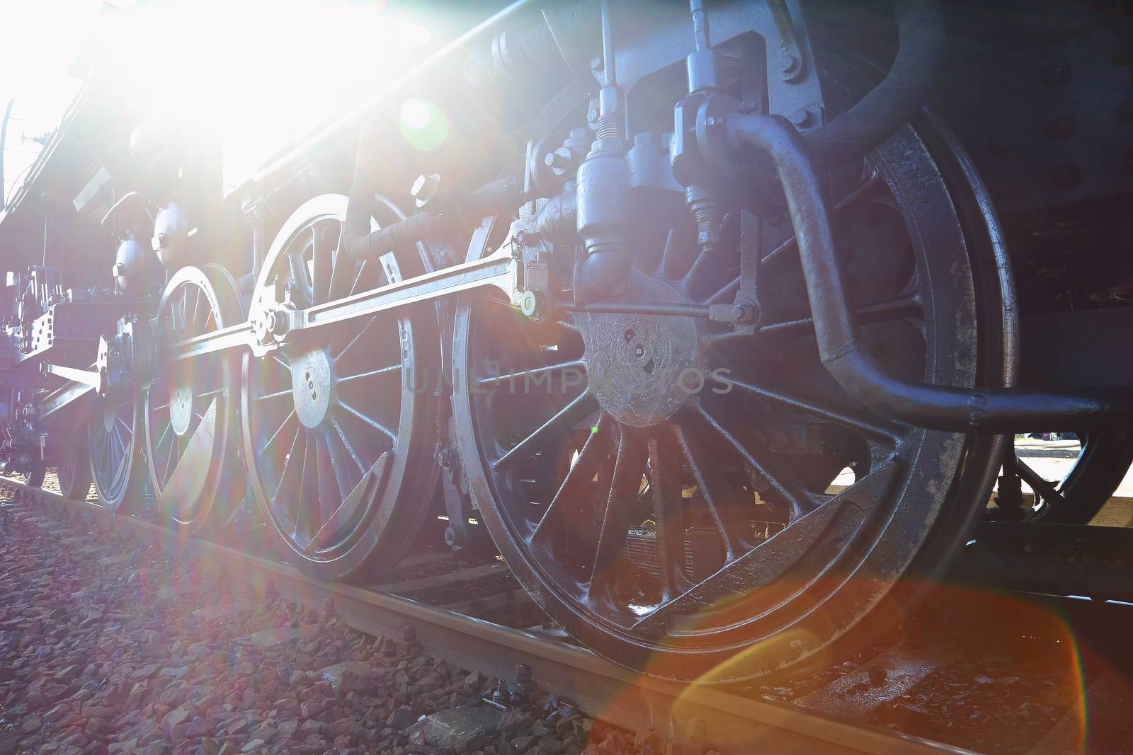 Steam locomotive with flaring sunlight