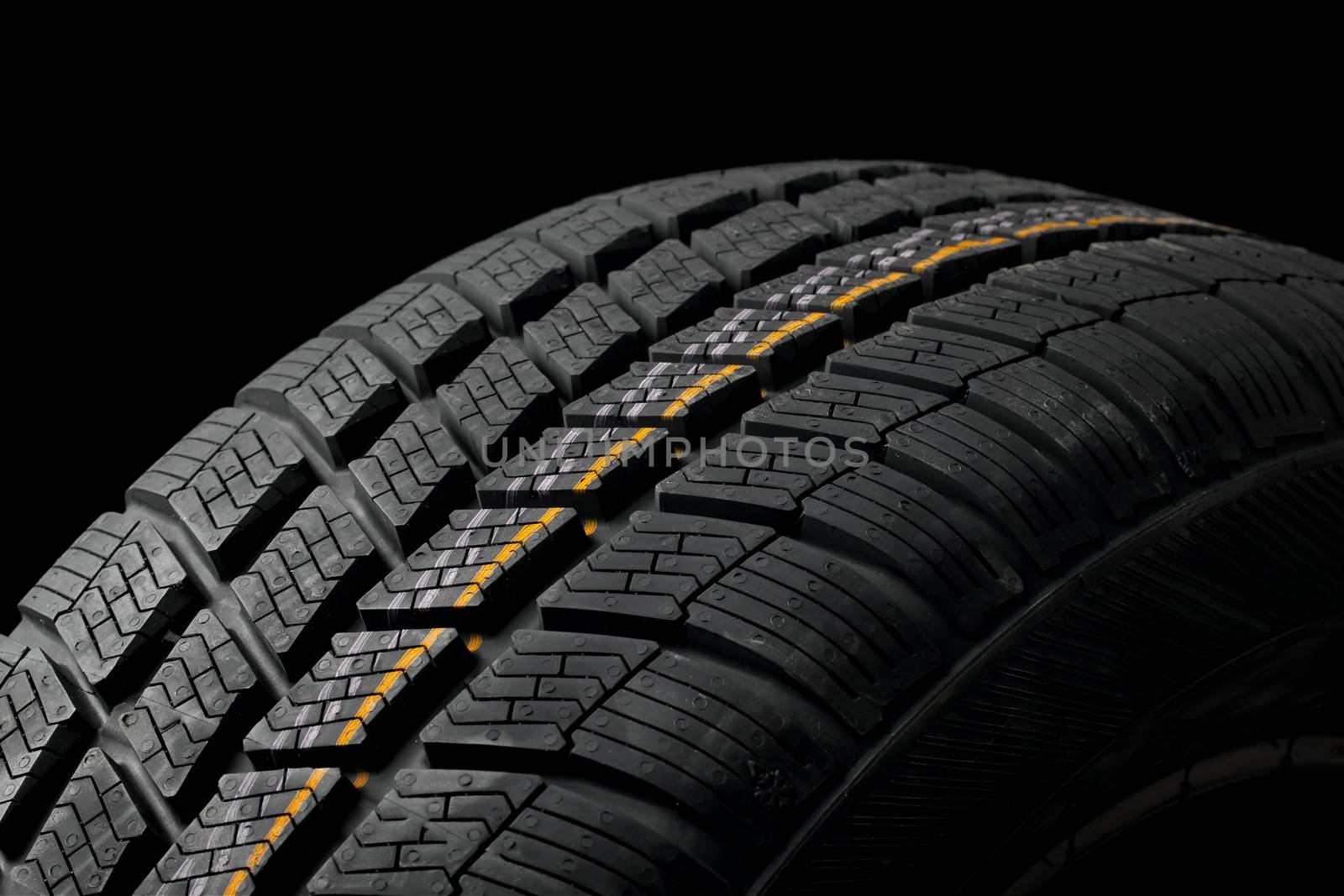Winter tyre closeup, dark backgroud