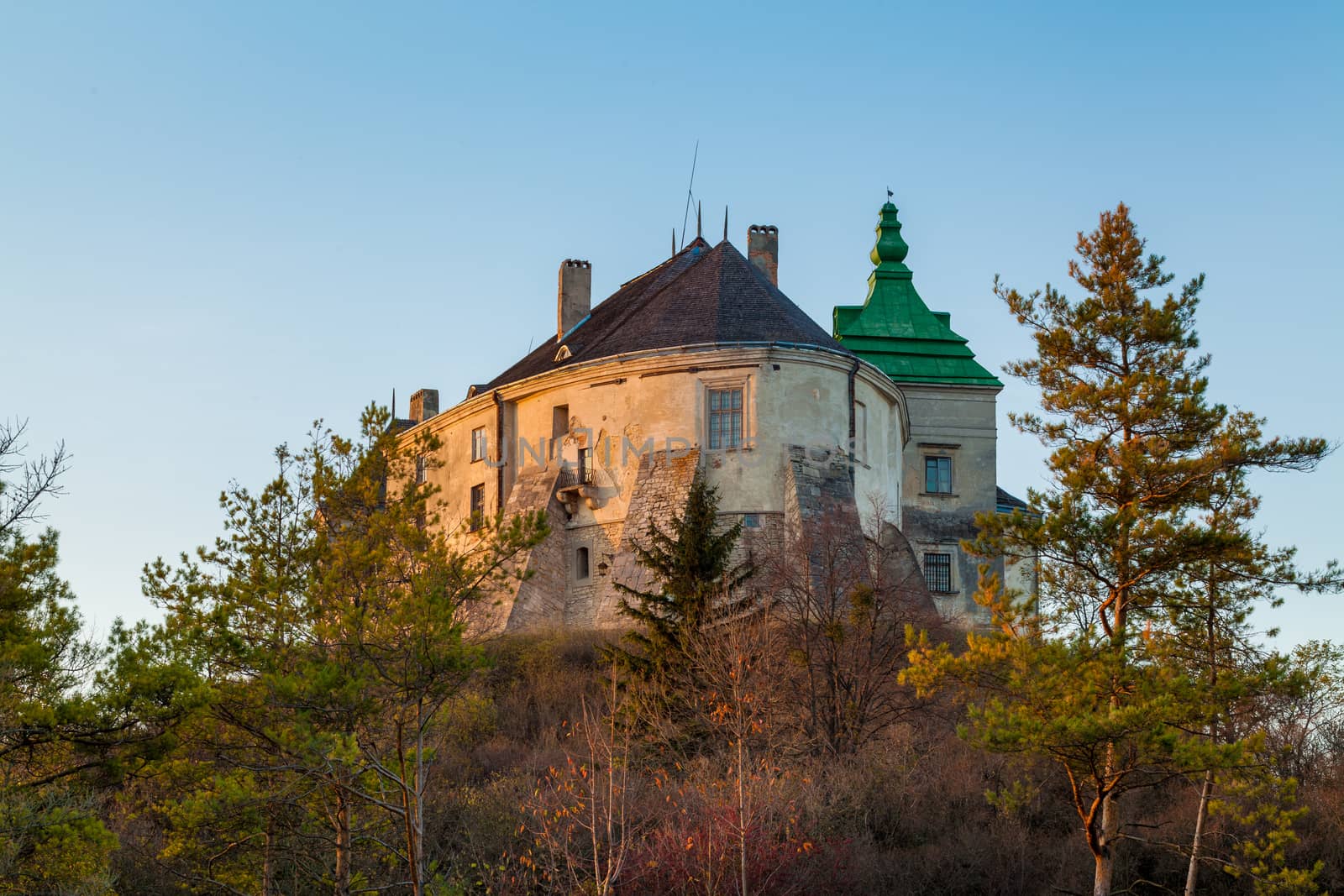 Ancient castle in the morning fog. Autumn season