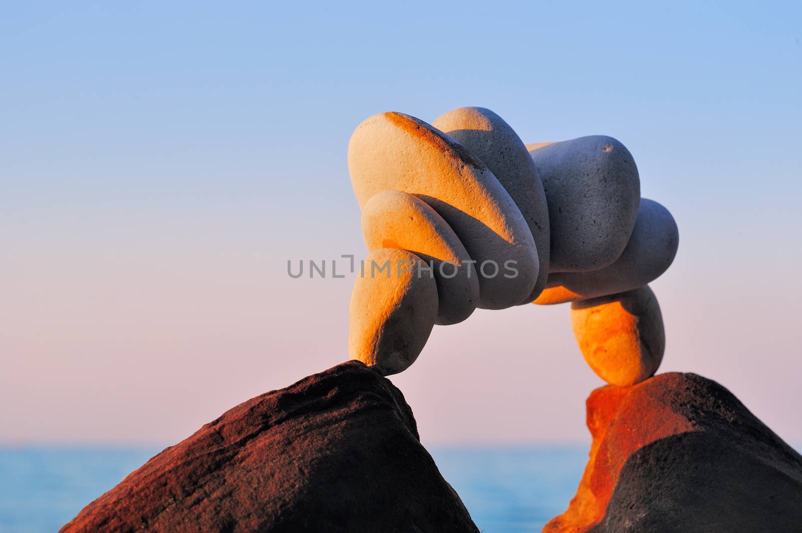 Stone arch between of two boulders on the coast