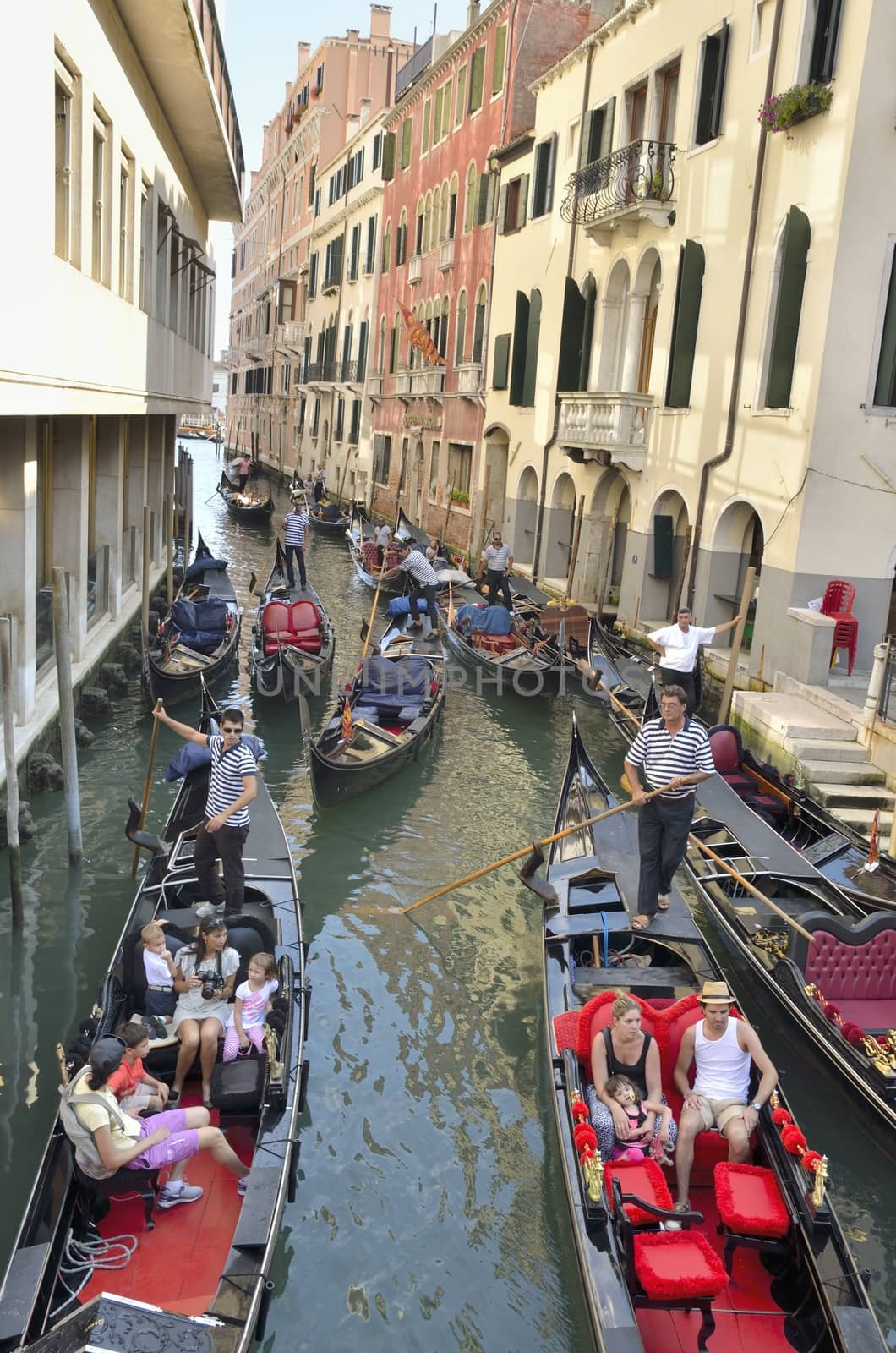 Typical view of the city with lots  of gondolas in a narrow canal in Venice, Italy