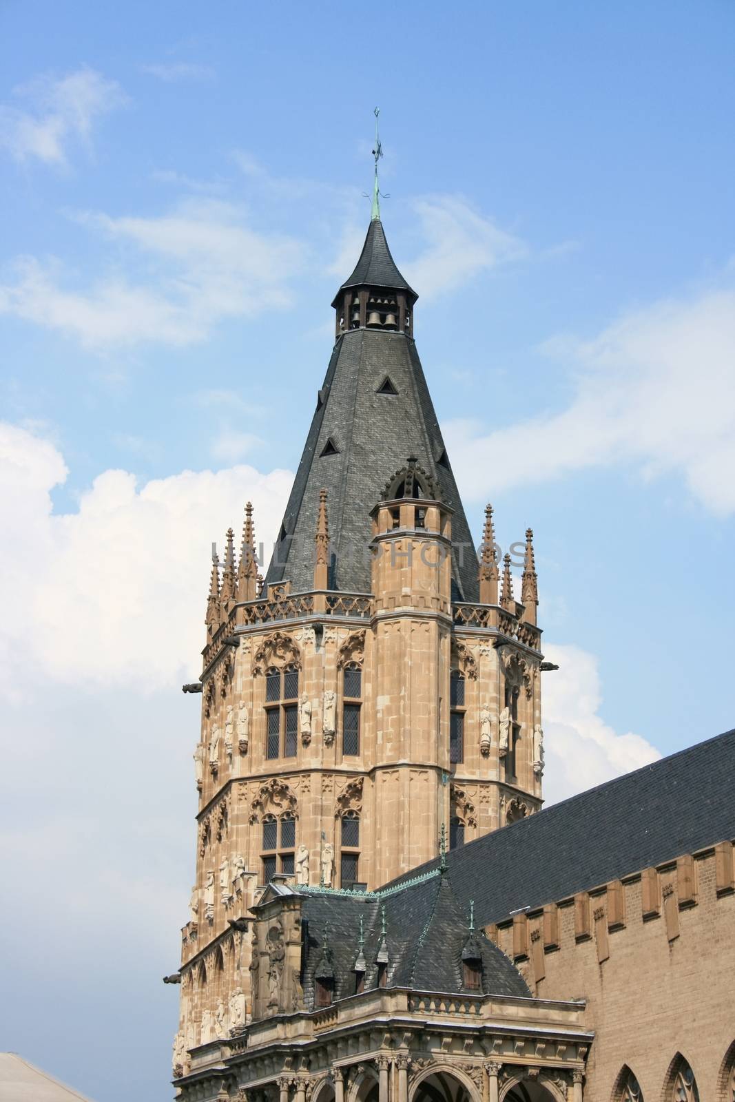 Detailed view of an imposing bell tower, blue sky in background