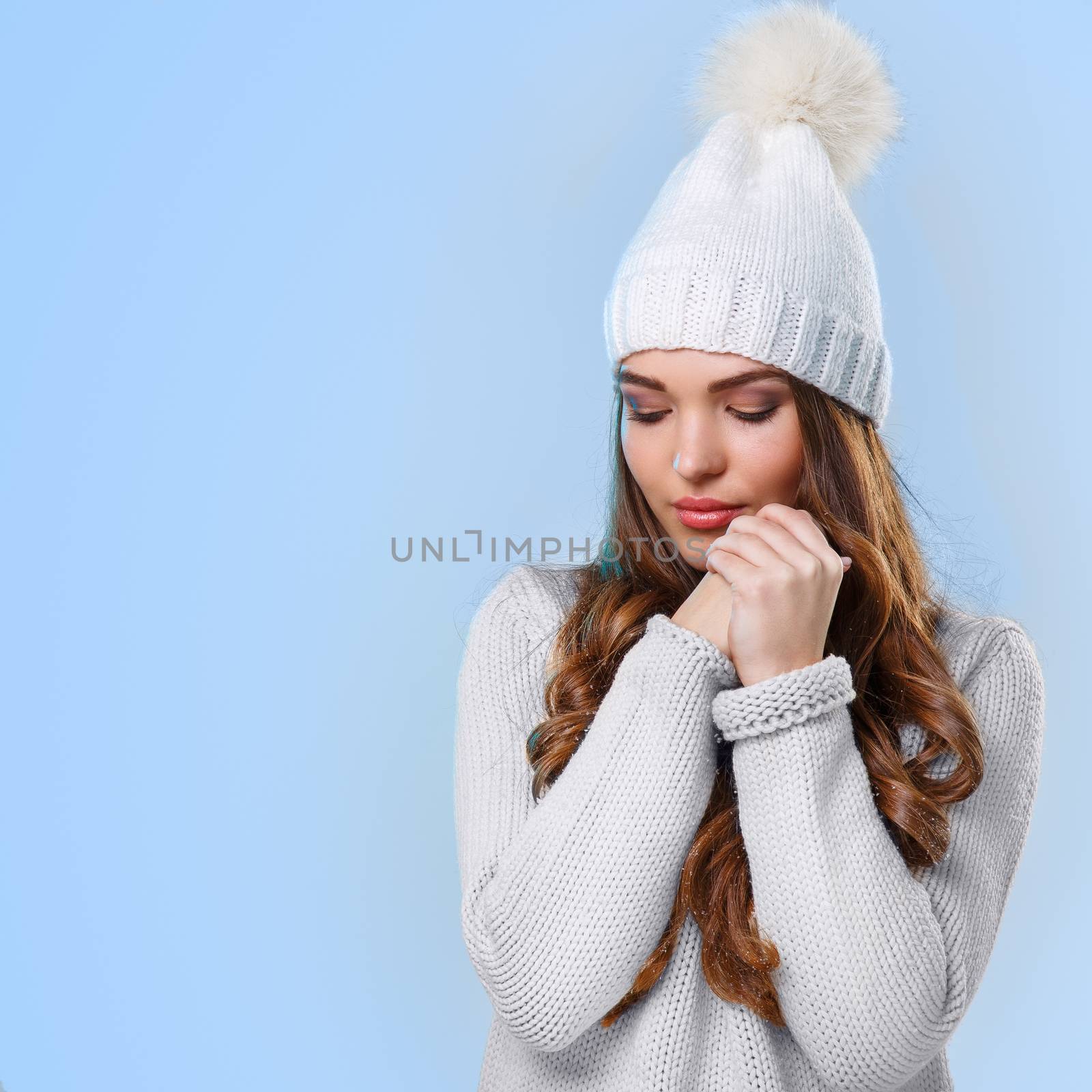 Winter. Cute girl on a blue background