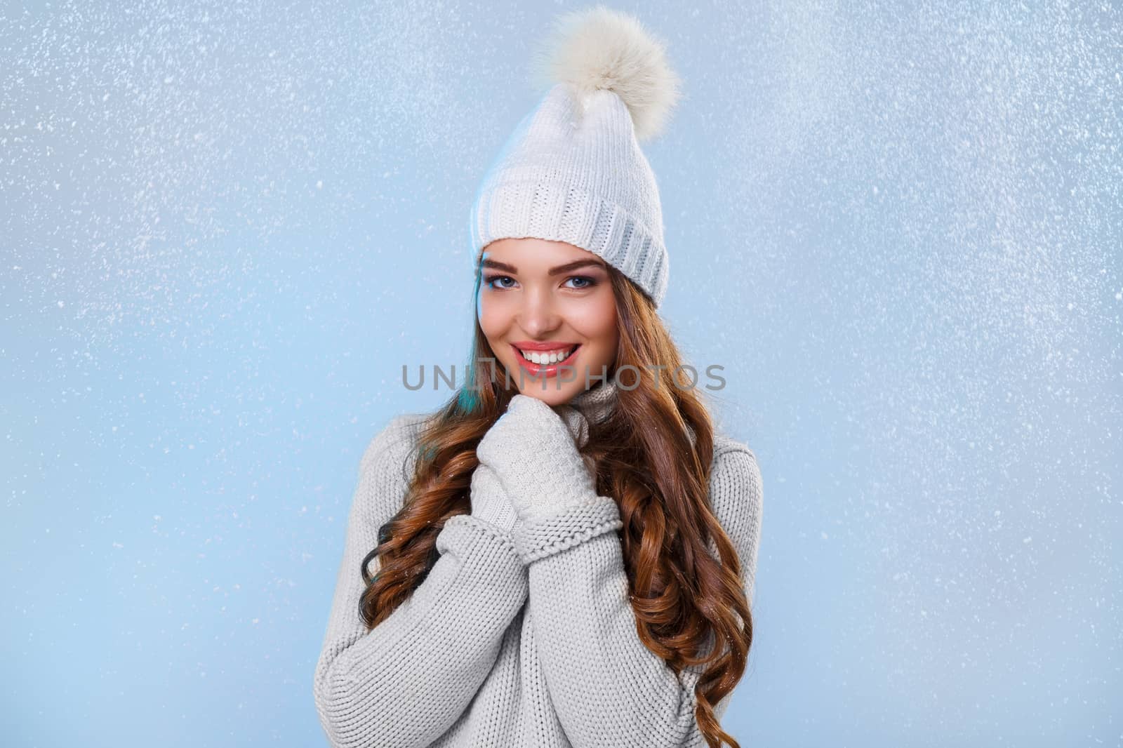 Winter. Cute girl during snowfall