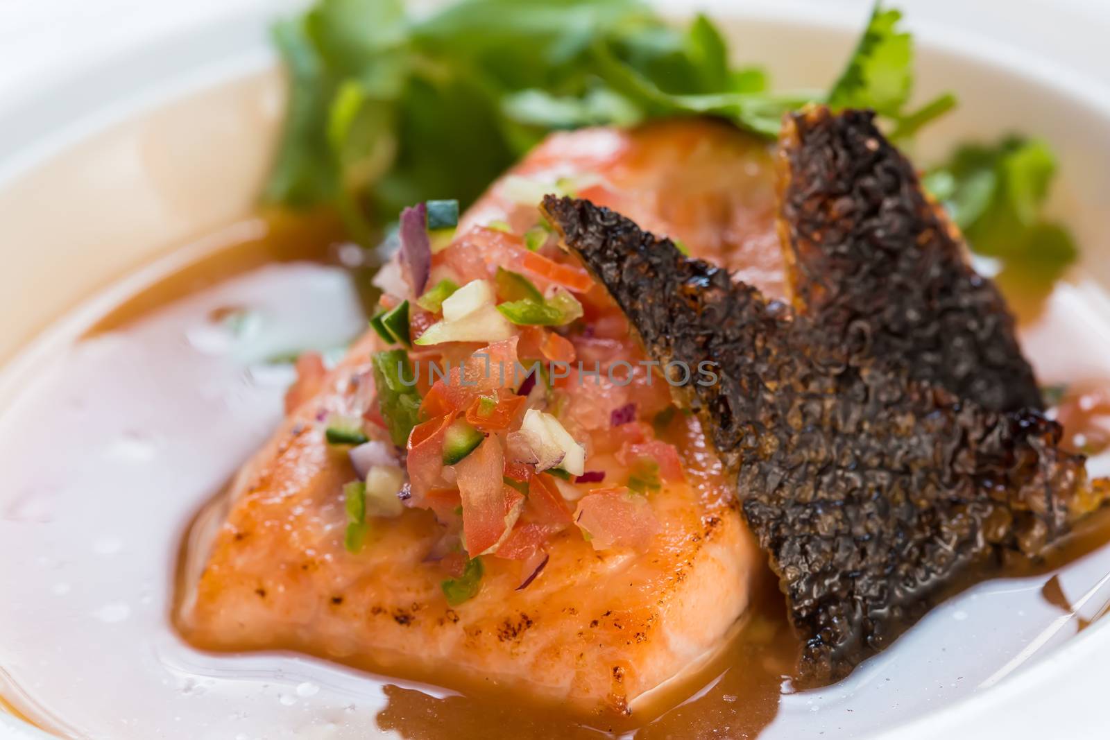 fish soup in white plate. selective focus