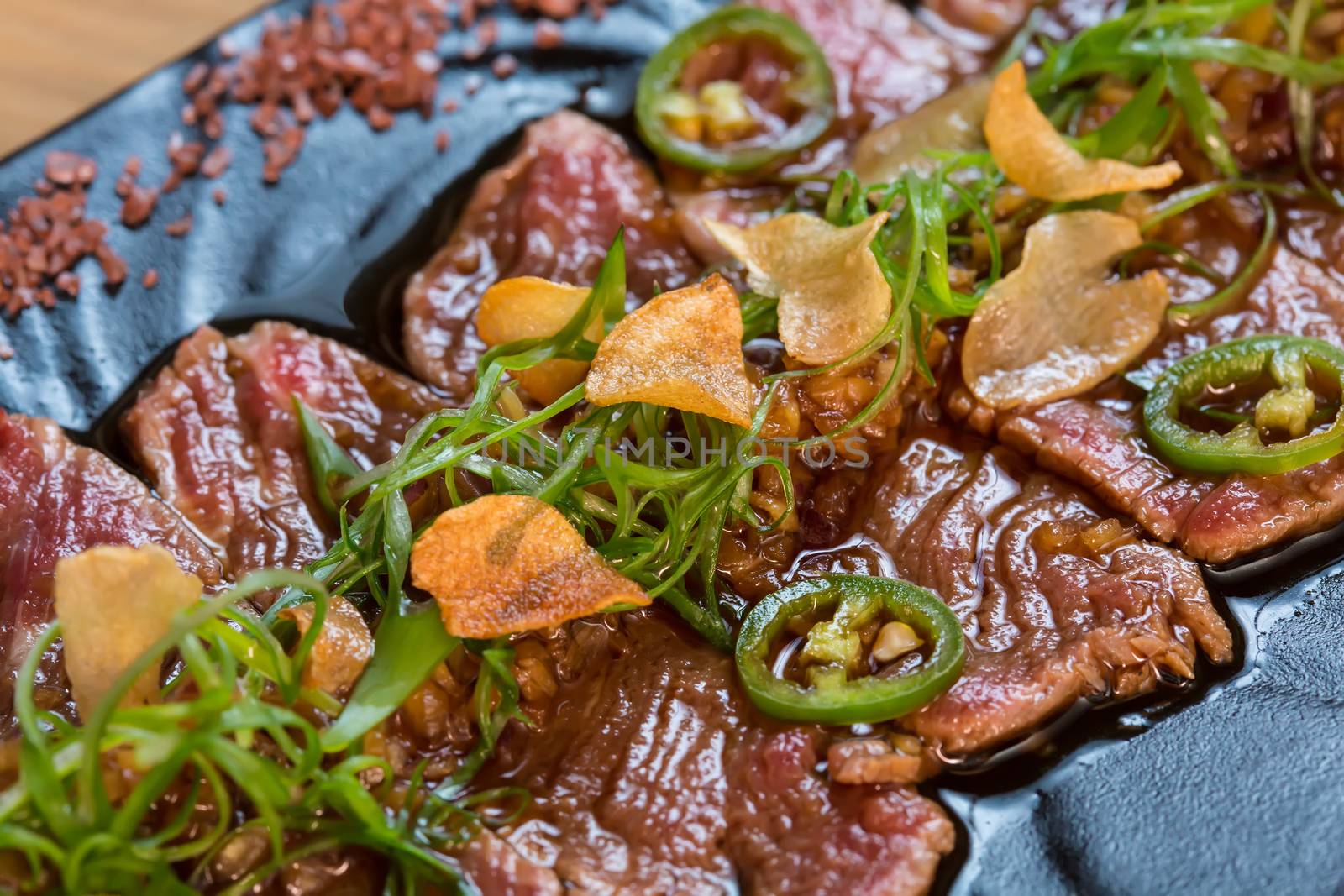 Beef Carpaccio on dark background by sarymsakov