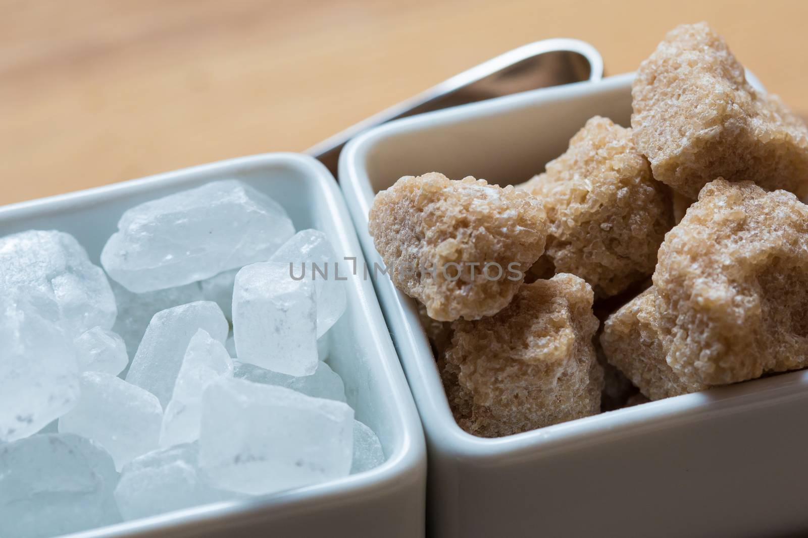 white and brown sugar on wooden table. Selective focus