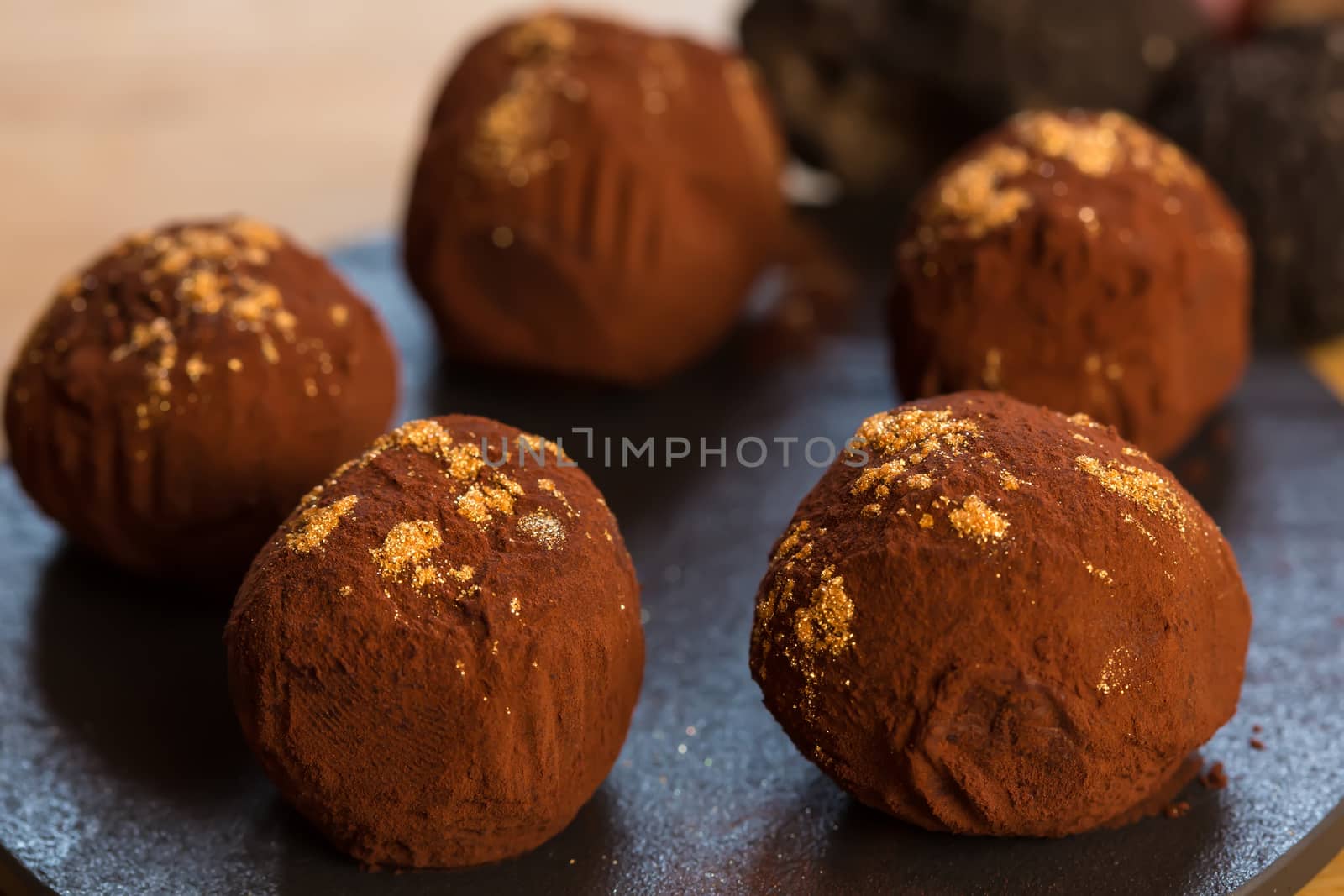 delicious chocolate truffles with golden. Selective focus