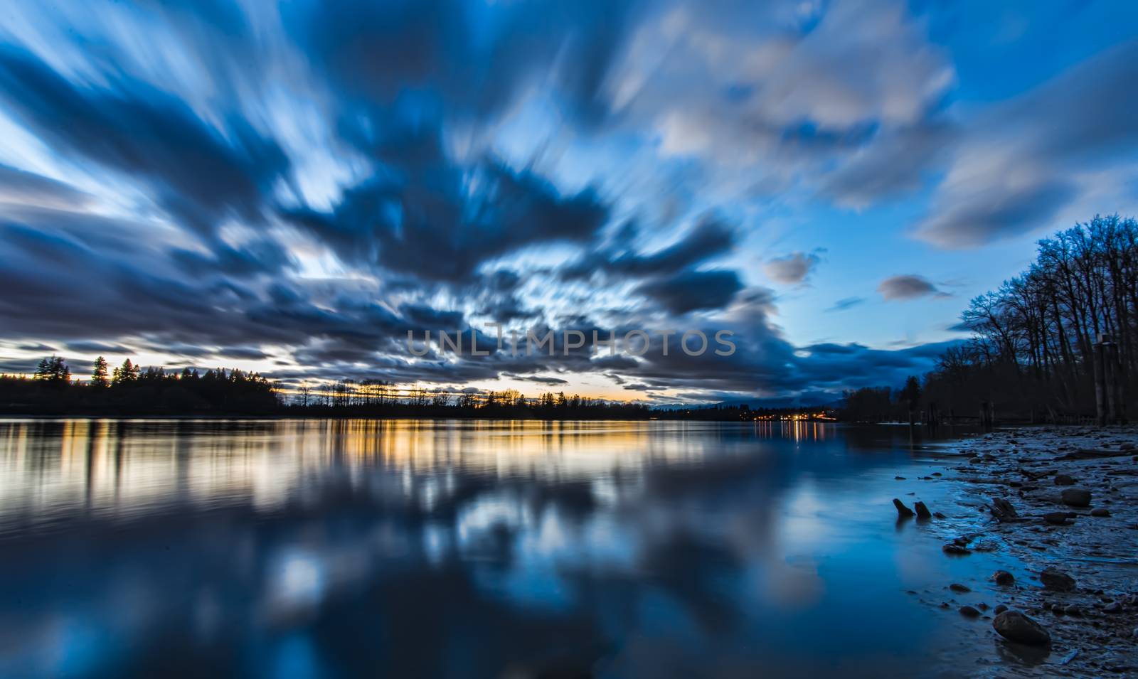 Blue Blurred Moving Clouds Over River by JamesWheeler