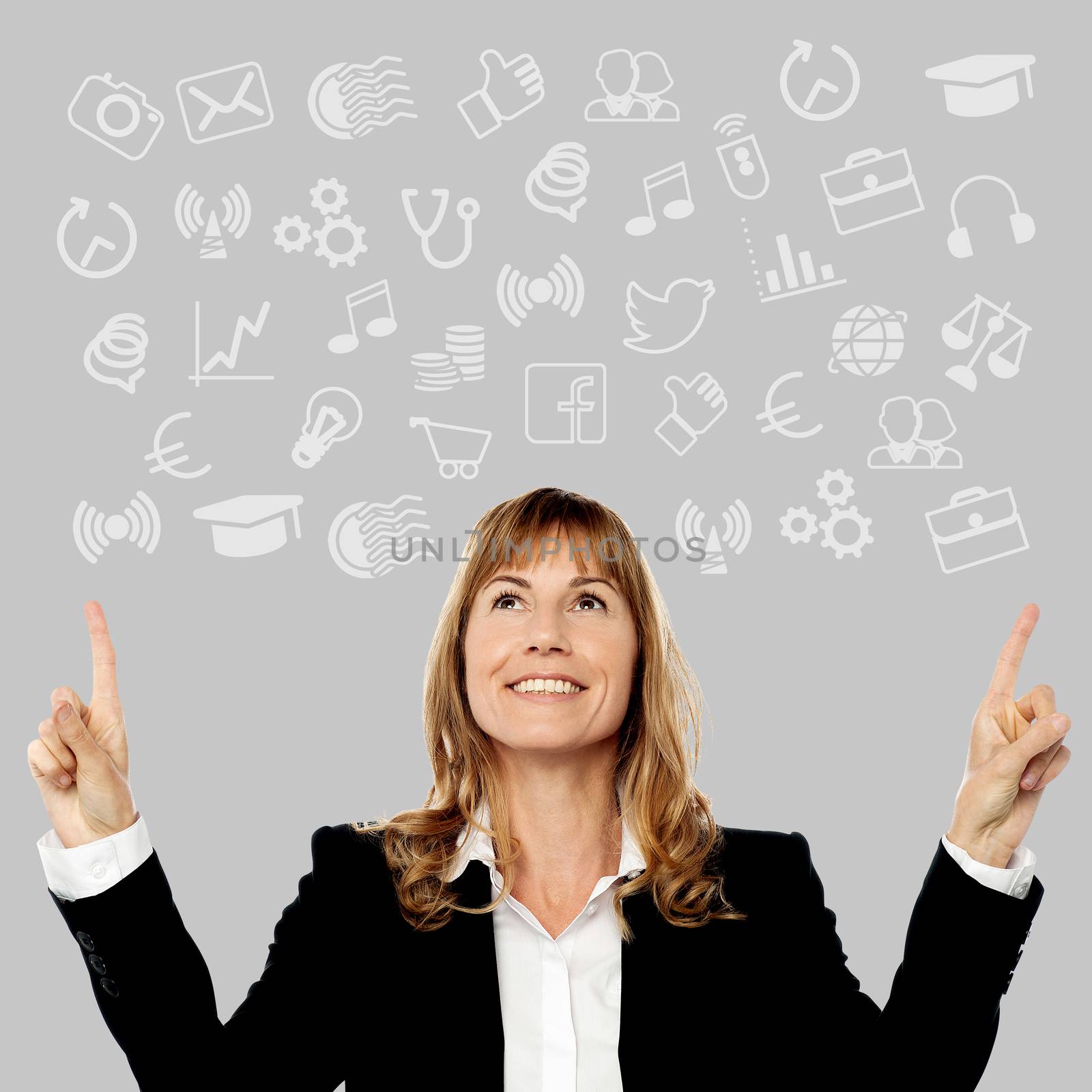 Middle aged woman pointing media icons by stockyimages