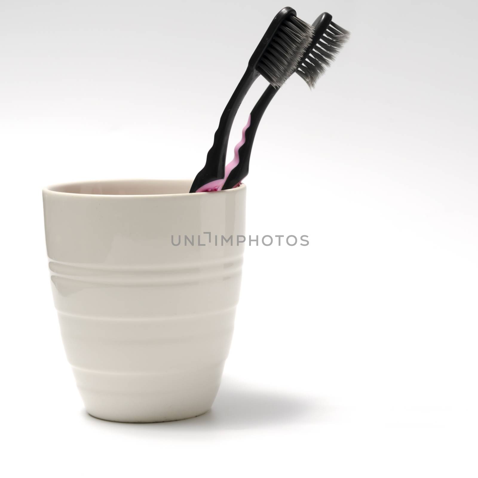 tooth brush in glass on a white background