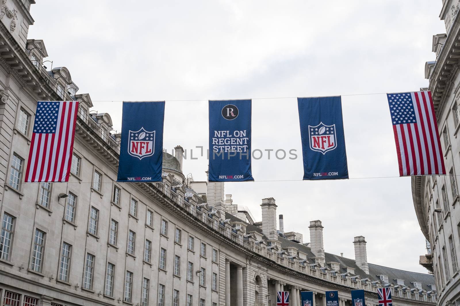 LONDON, UK - SEPTEMBER 27: American flag and NFL banners hanging above in Regent street. September 27, 2014 in London. Regent street was closed to traffic to host NFL related games and events.