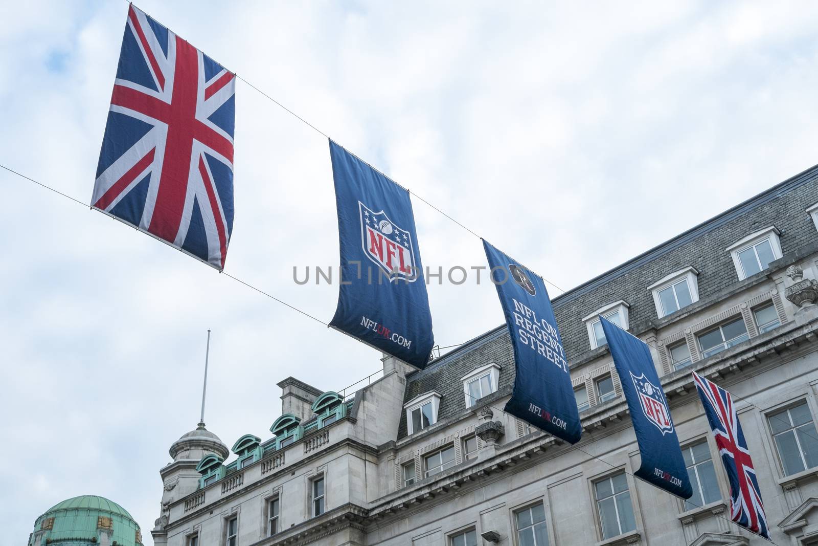 LONDON, UK - SEPTEMBER 27: Union Jack and NFL banners hanging in Regent street. September 27, 2014 in London. Regent street was closed to traffic to host NFL related games and events.