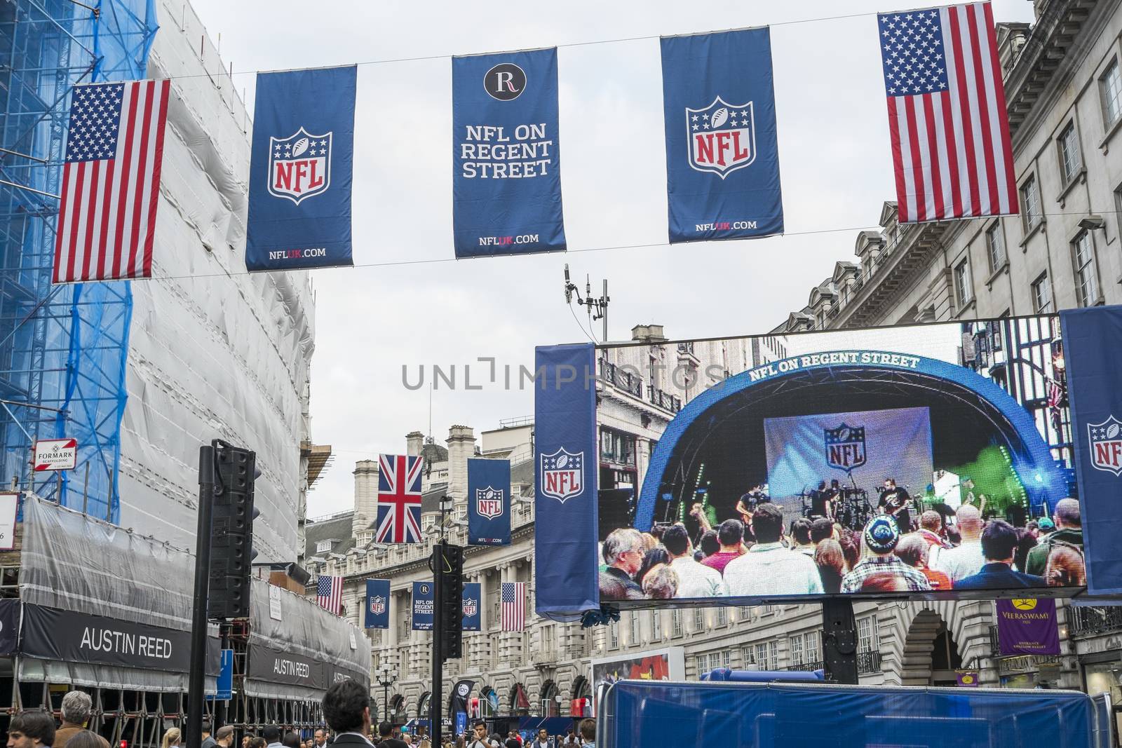 LONDON, UK - SEPTEMBER 27: American flag and NFL banners hanging above screen on Regent street. September 27, 2014 in London. Regent street was closed to traffic to host NFL related games and events.