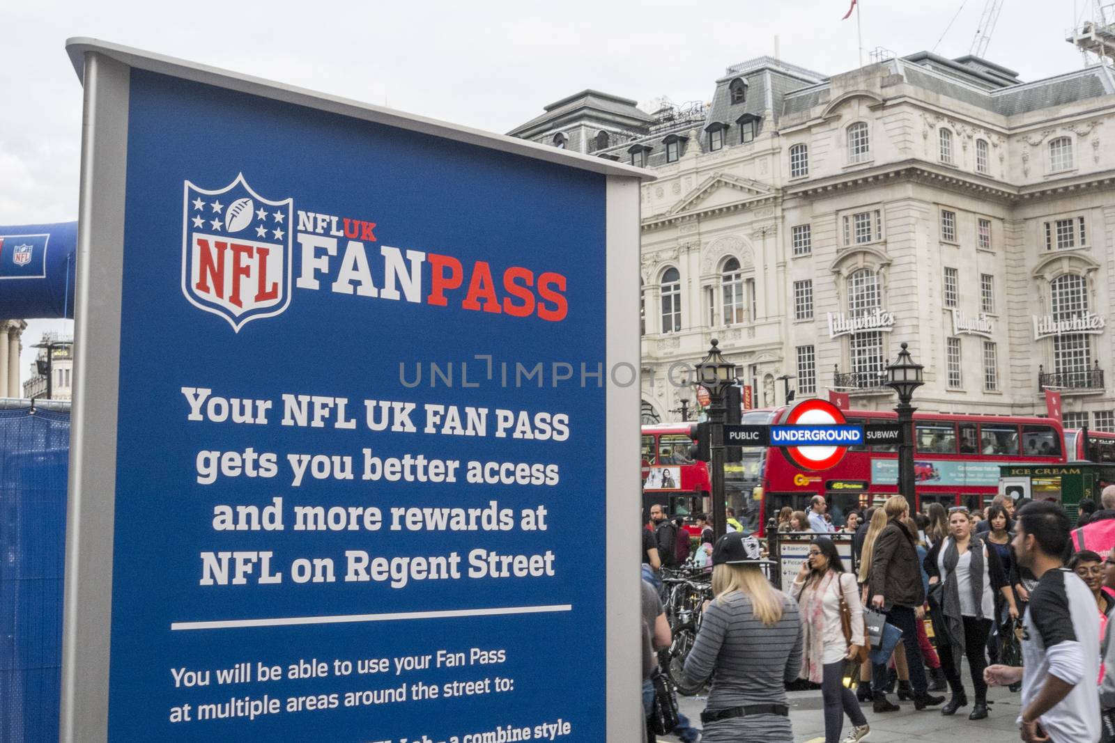 LONDON, UK - SEPTEMBER 27: NFL billboard with London underground entrance in Regent Street. September 27, 2014 in London. The street was closed to traffic to host NFL related games and events.