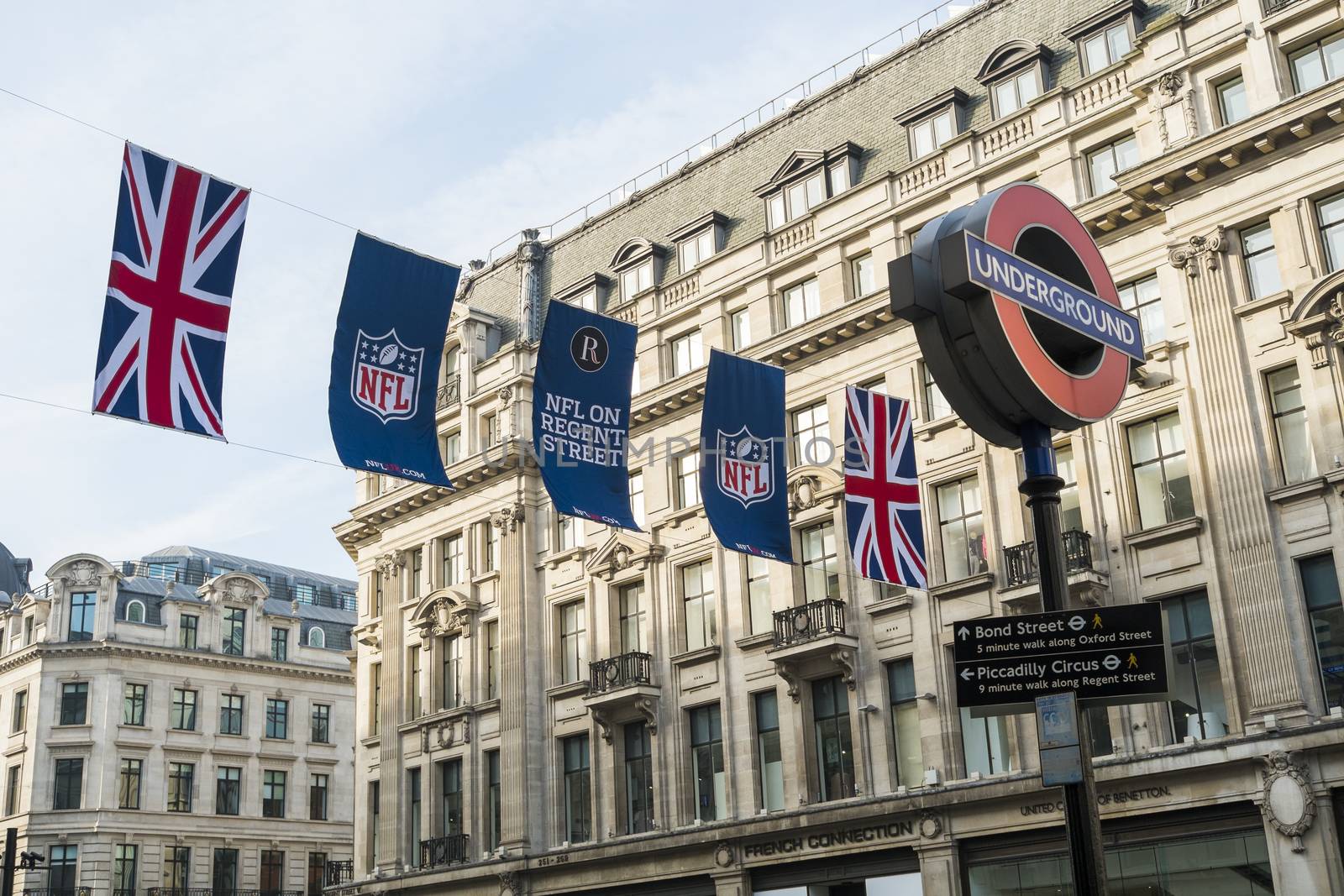 LONDON, UK - SEPTEMBER 27: Union Jack and NFL banners with London Underground sign post. September 27, 2014 in London. Regent street was closed to traffic to host NFL related games and events.