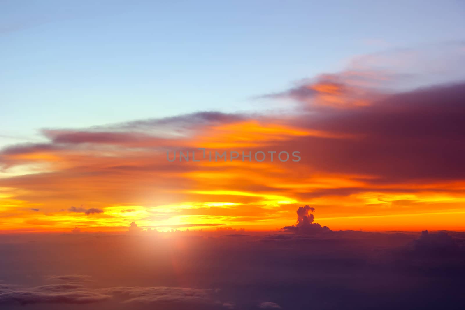 Sunset with clouds over view from airplane flying