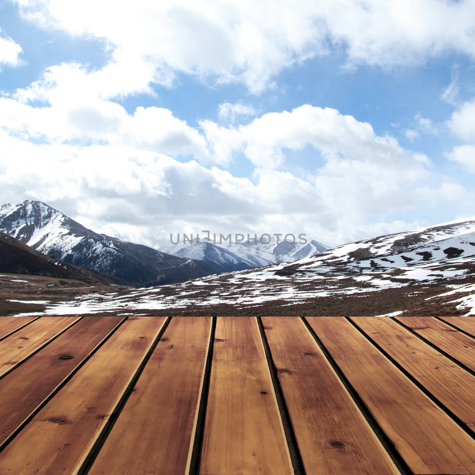 Snow mountain with sky and wood floor for background