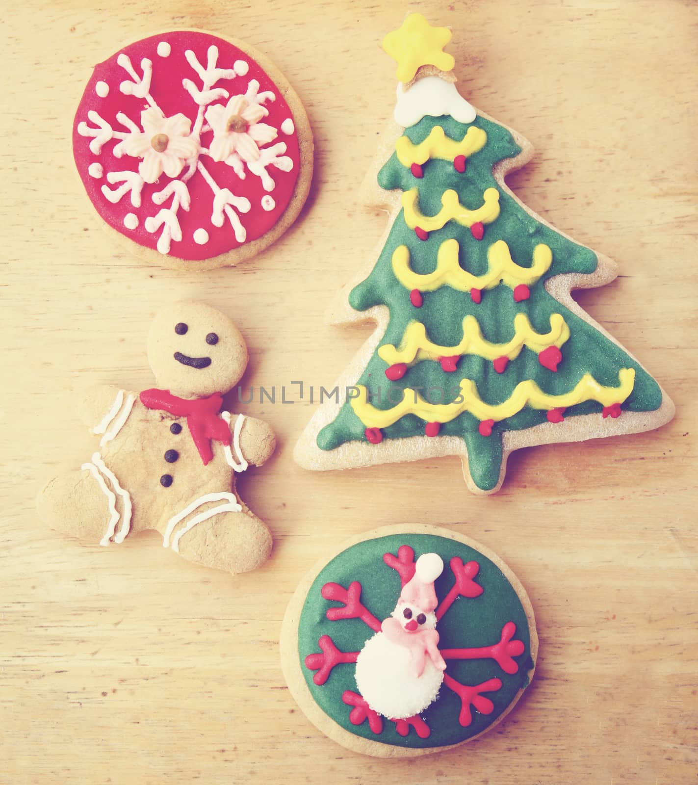 Decorated christmas gingerbreads on wooden background with retro by nuchylee