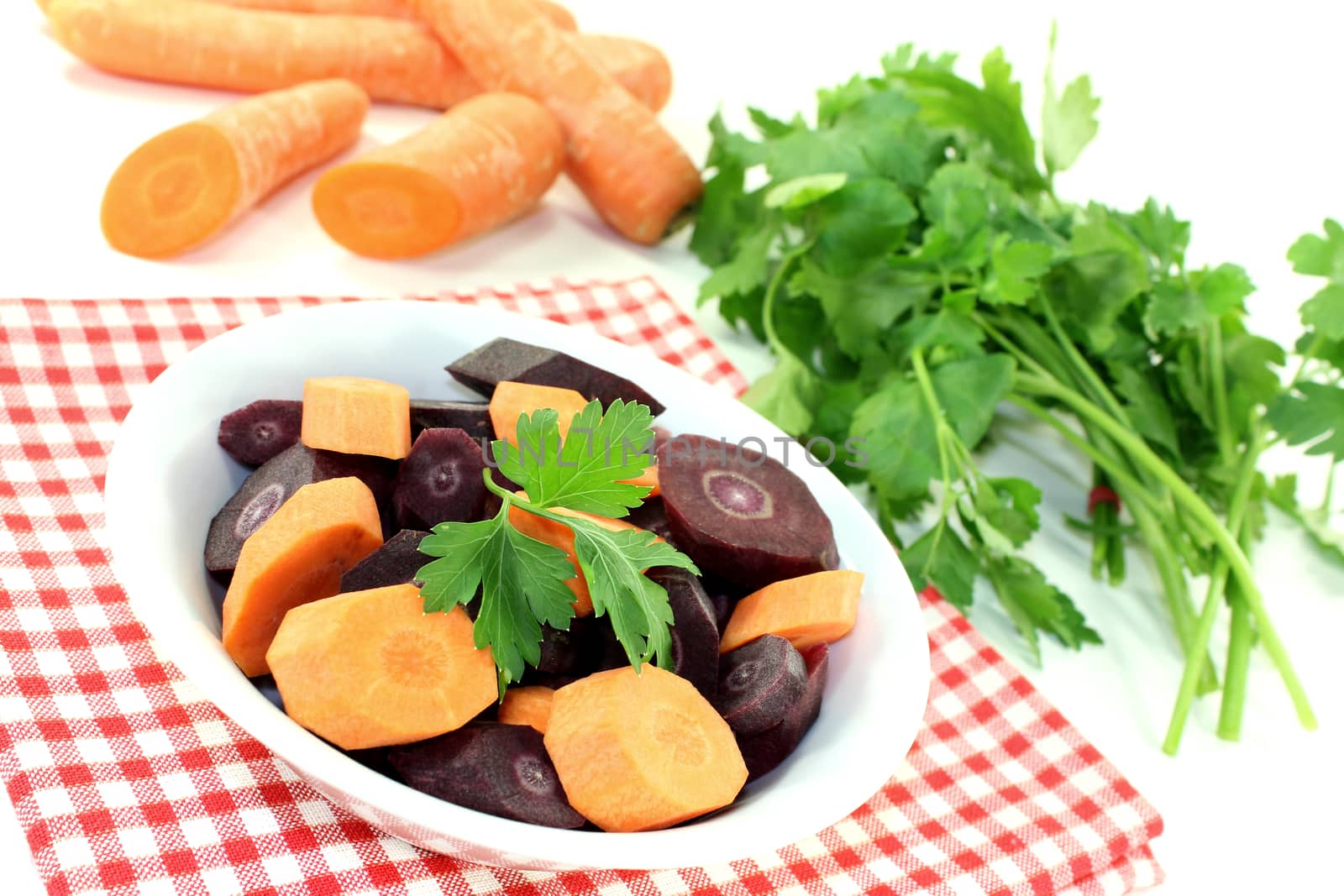 fresh crisp orange and purple carrots by discovery