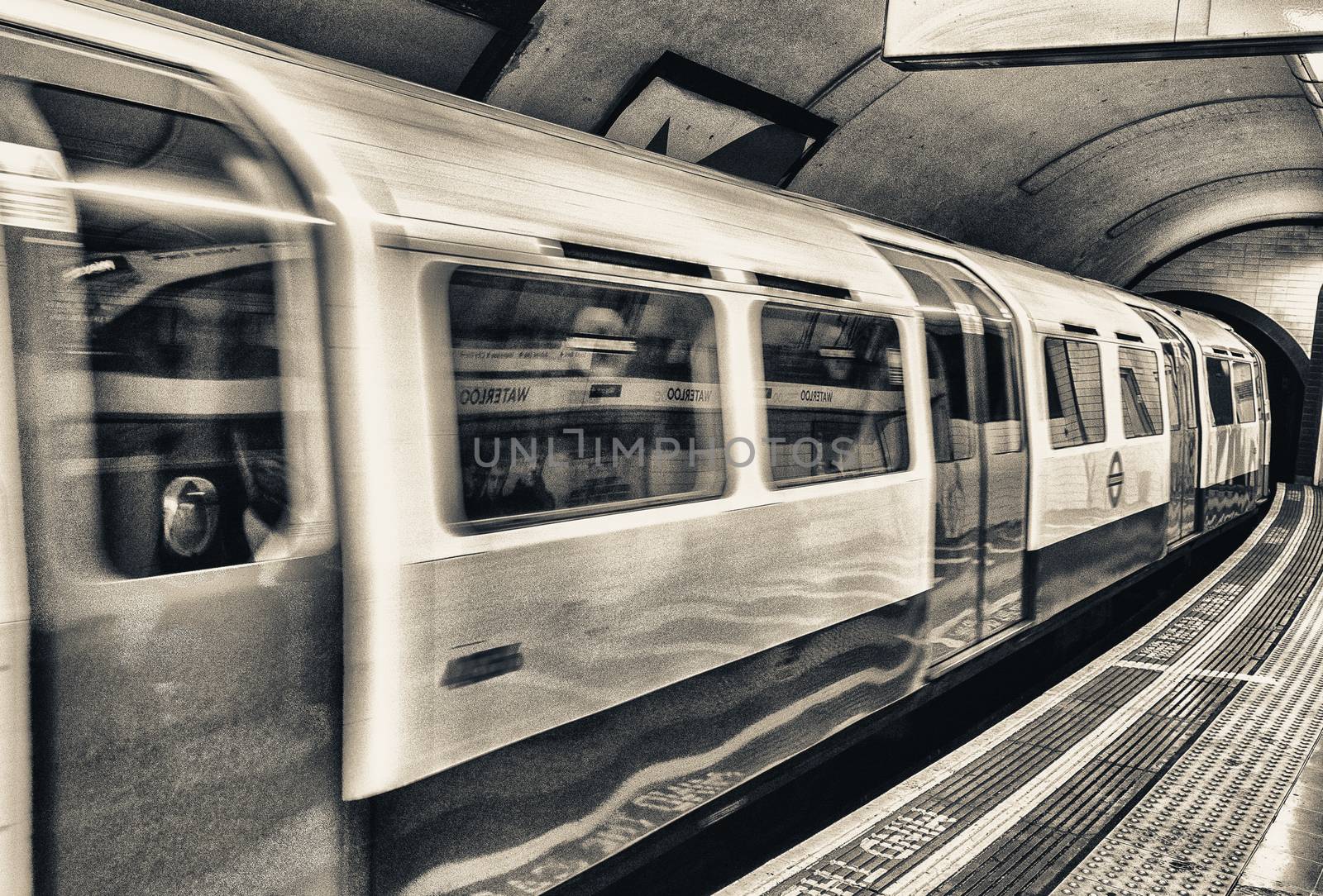 A subway train in motion arriving at a London underground train by jovannig
