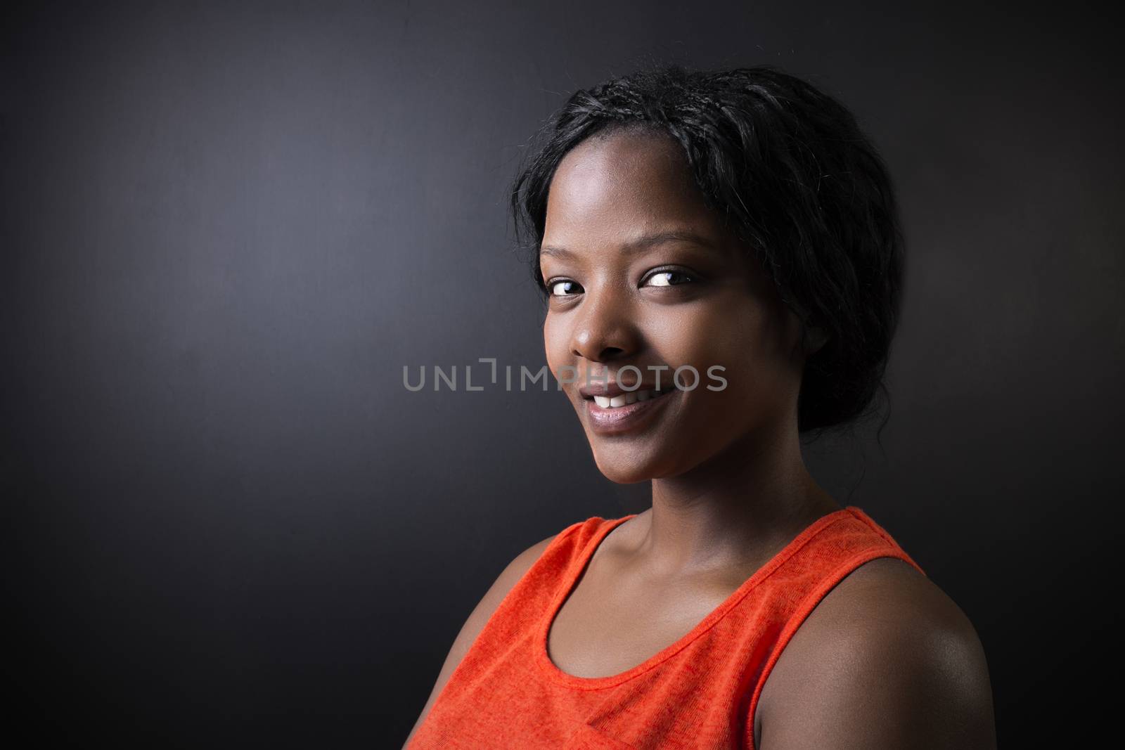 South African or African American woman teacher or student on chalk black board background