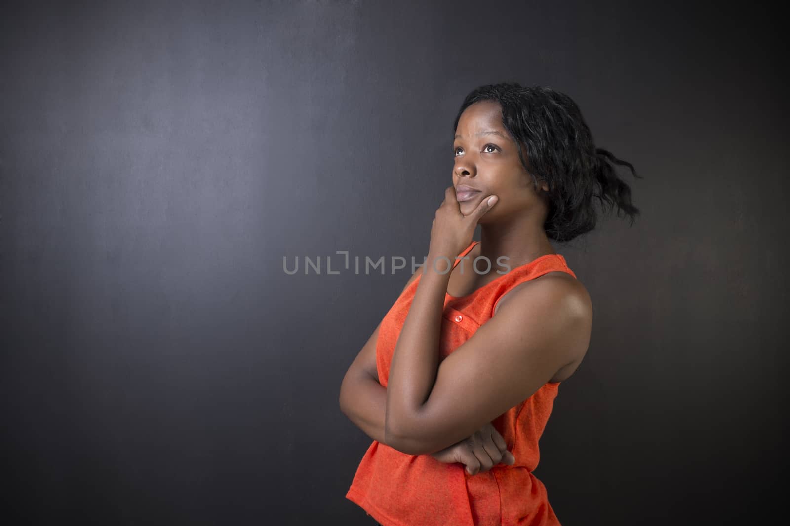 South African or African American woman teacher on chalk black board background by alistaircotton