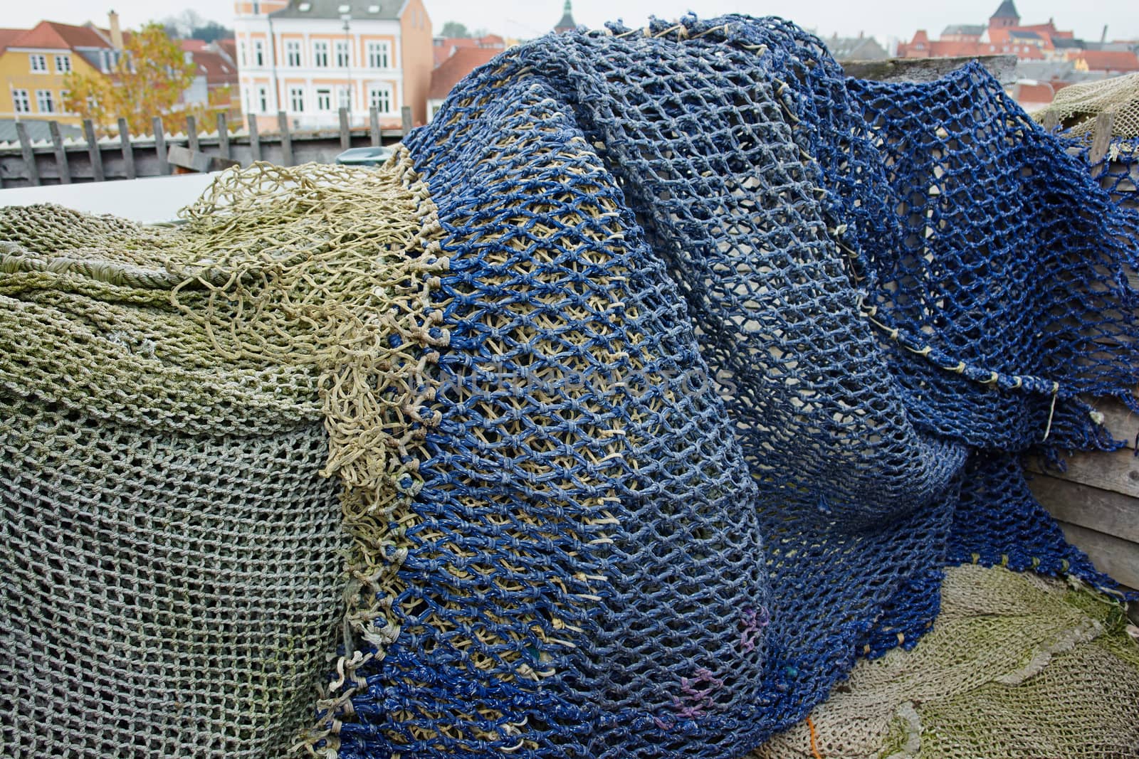 Details of colorful fishing nets in a fishermen port background                               