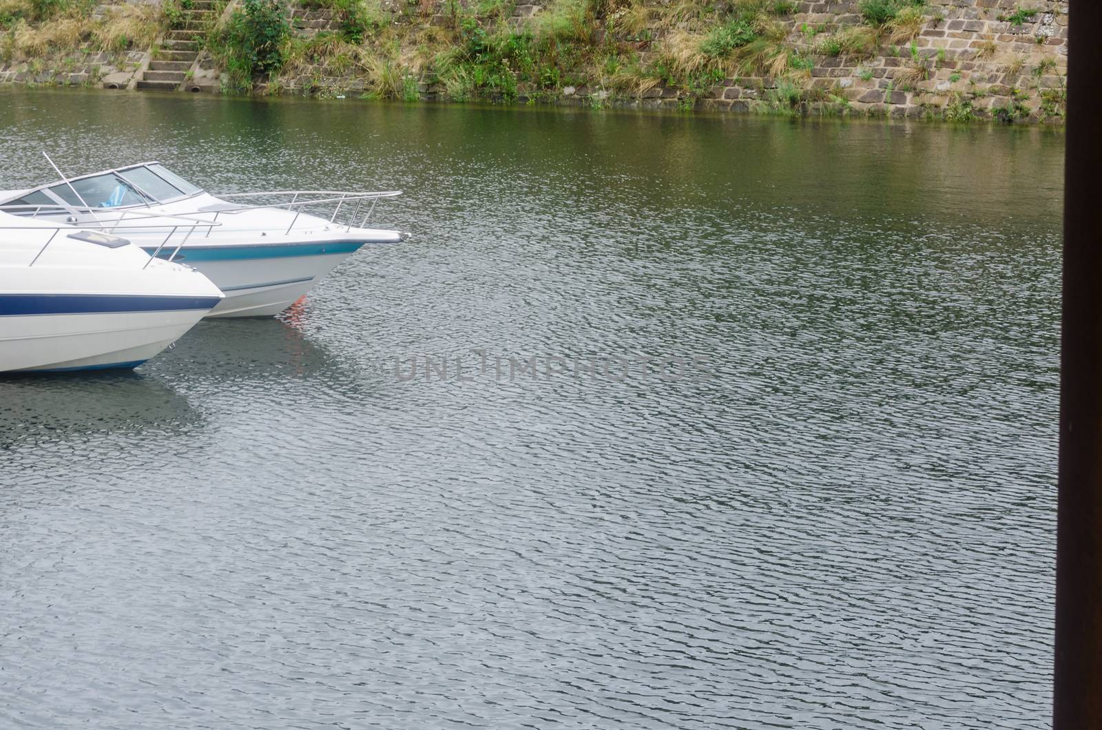 Nose cone of two motor boats in a marina.