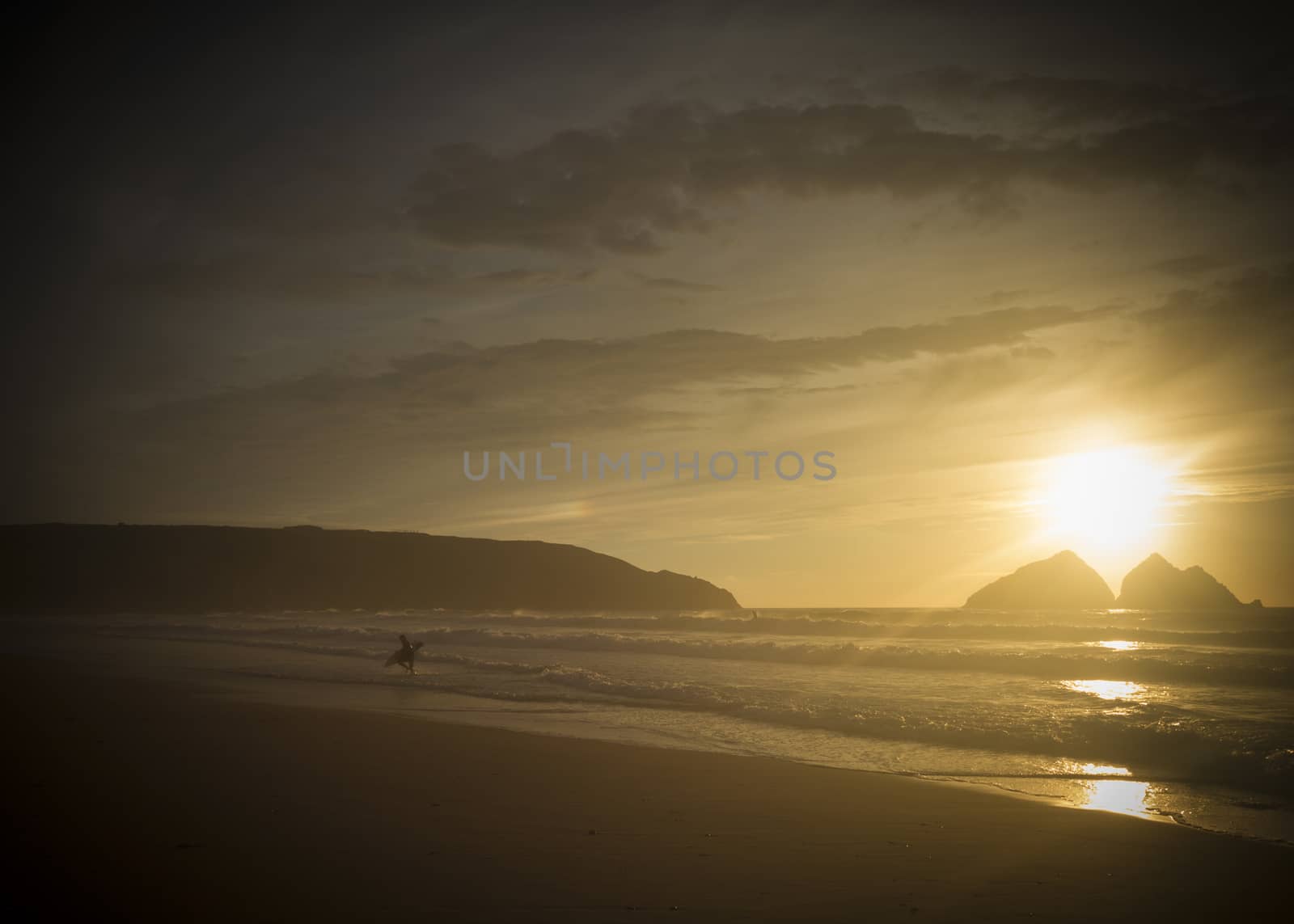 silhouette of a surfers  at sunset,  holywell bay, newquay UK