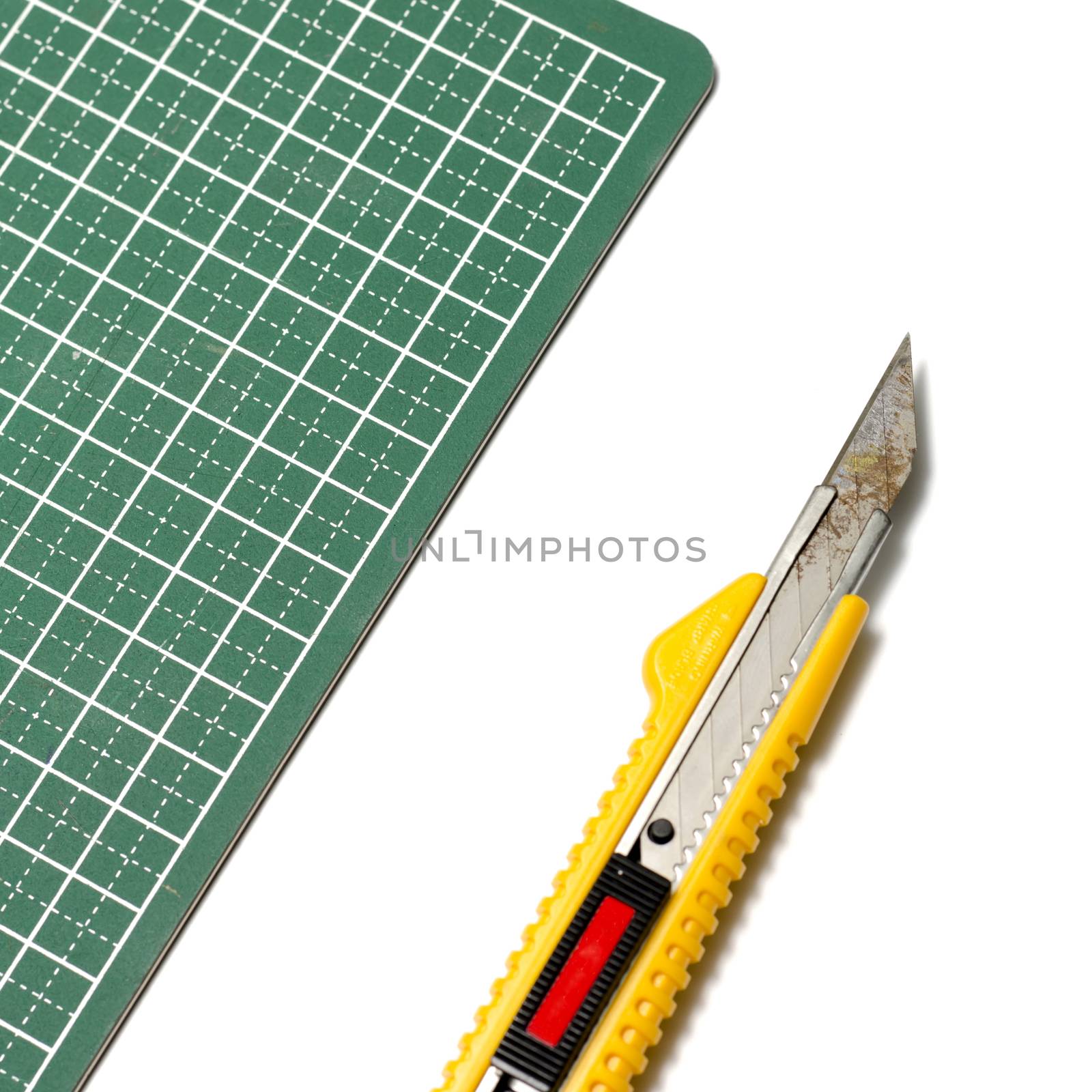 cutter knife on cutting board on a white background