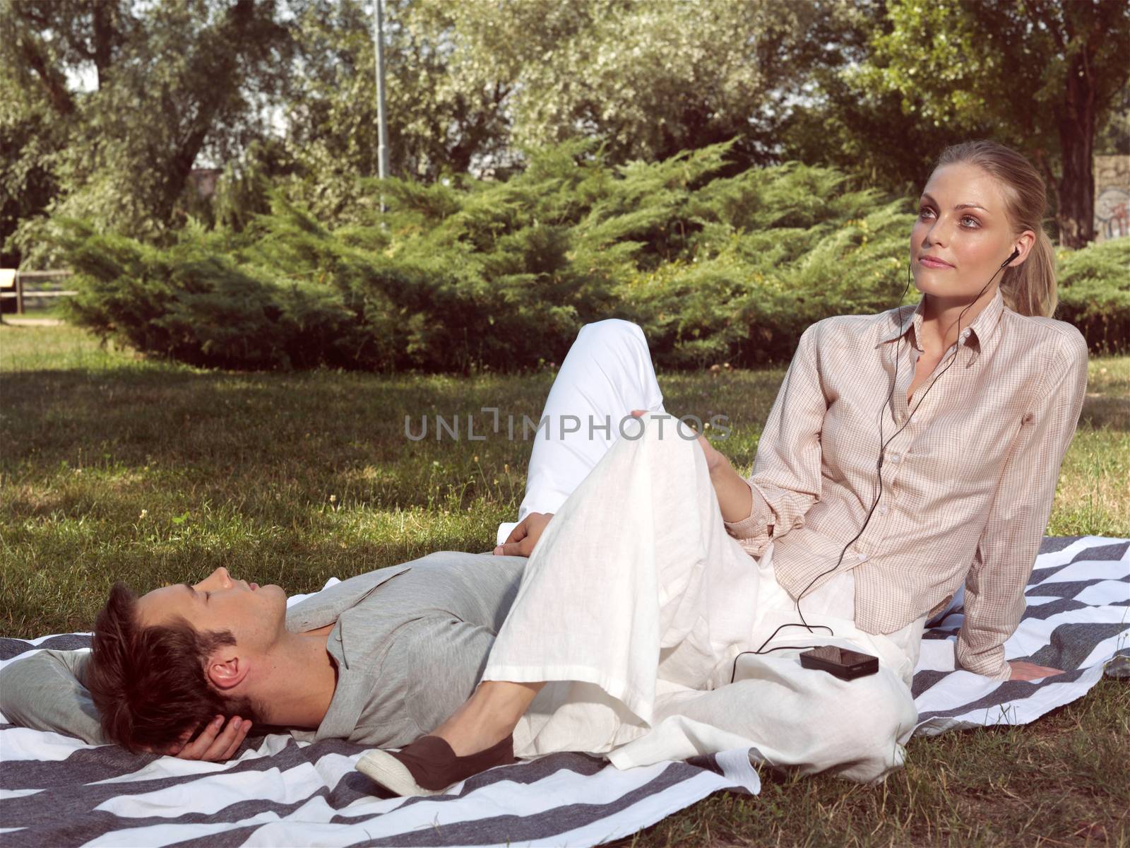young couple in love resting in the park 
