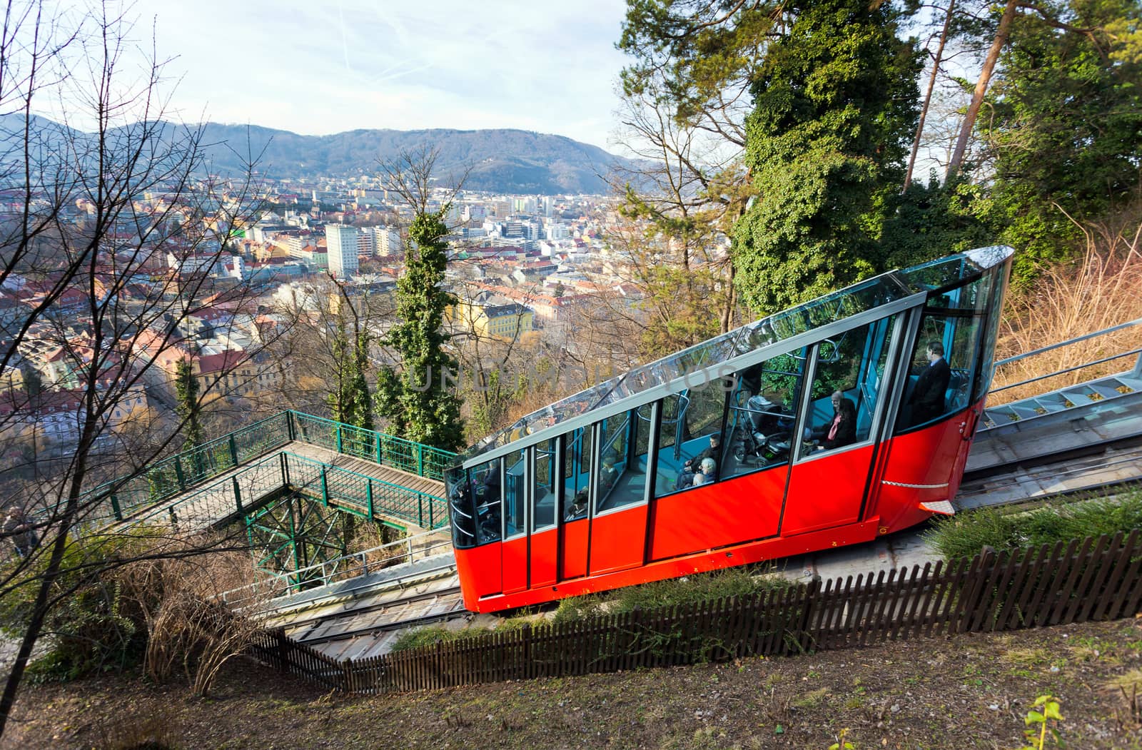 Graz, Austria - January 16, 2011:  Modern funicular climbing to Schlossberg and Graz city panoramic view, Austria