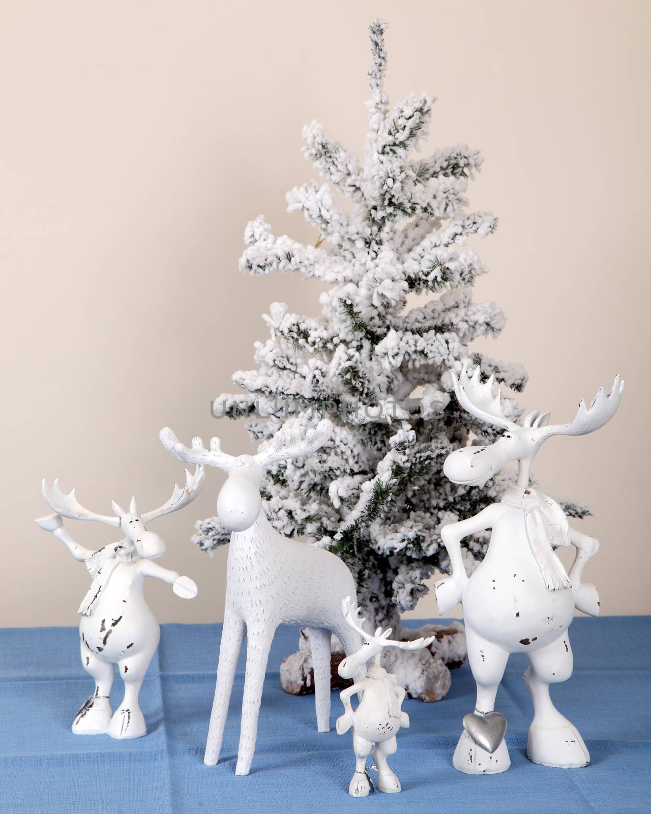 Composition from sculptures of toy elks and a New Year's elkiya of a fir-tree