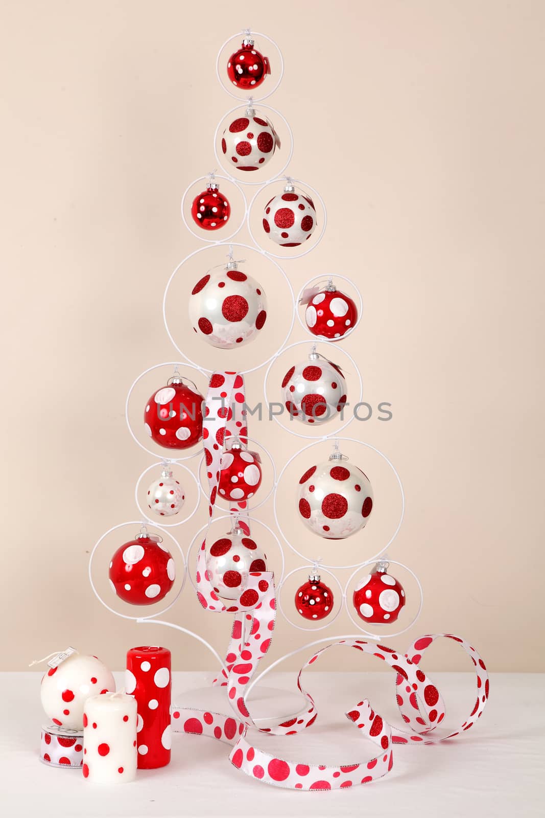 Composition in the form of a New Year tree, candles and red-white spheres