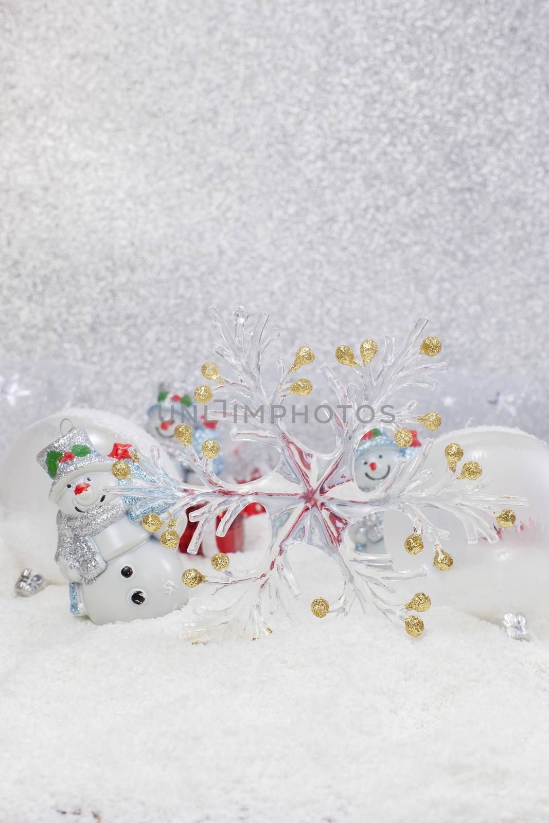 Cheerful snowman and Christmas tree decorations. Winter background. High key  with shallow depth of field