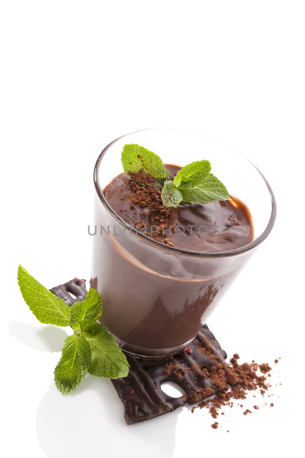 Chocolate pudding with fresh mint leaves and chocolate bar isolated on white background. Culinary sweet dessert.