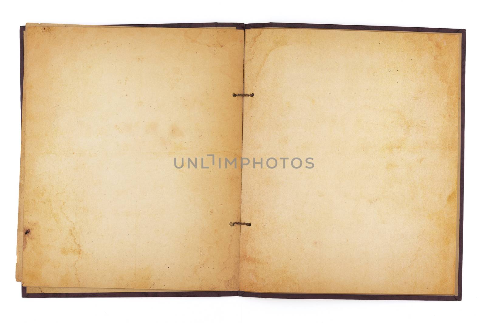 An aging scrapbook open to reveal blank, yellowing water-stained pages. Isolated on white. Includes clipping path.
