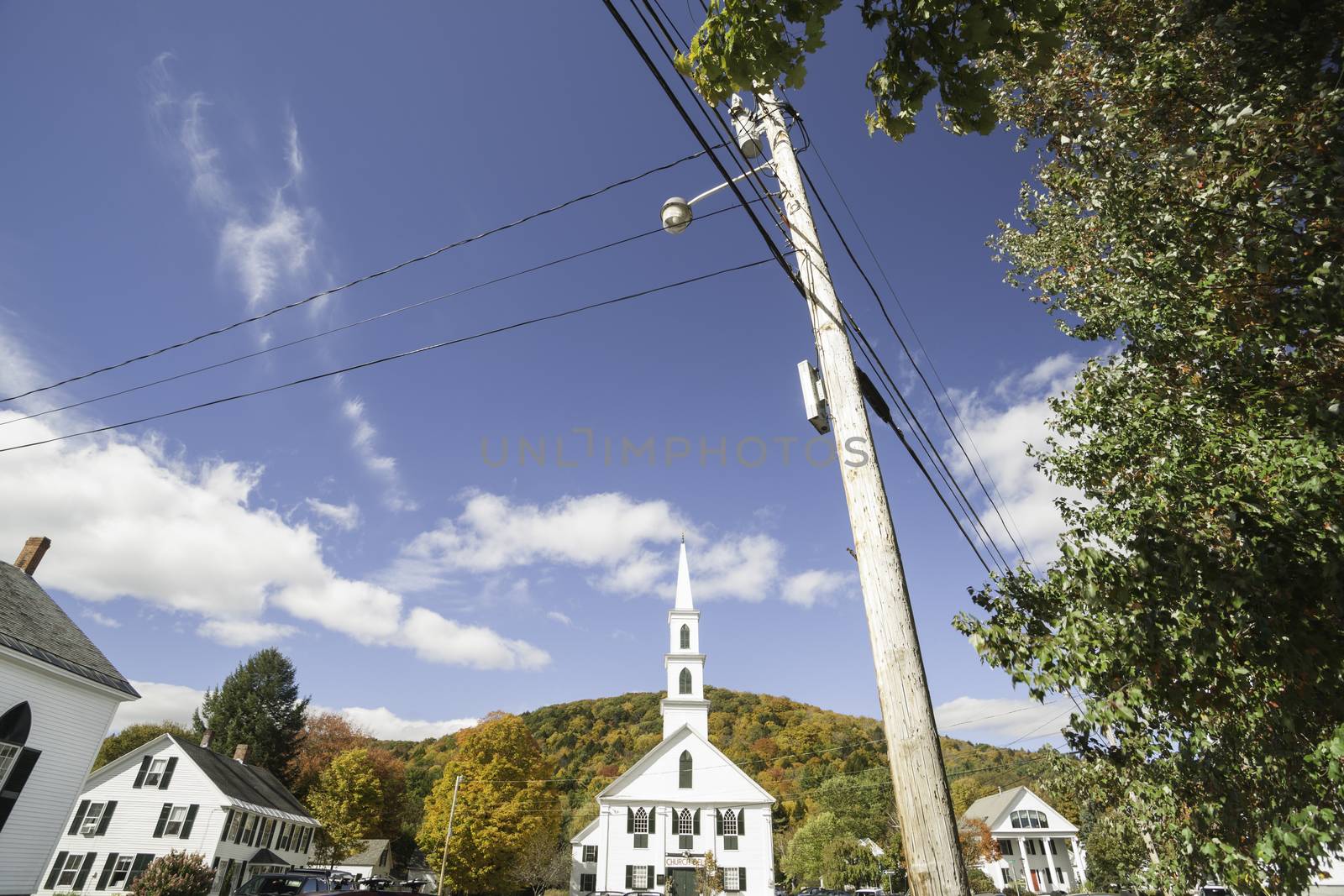 Small town America wide angle street scene in Newfane, Vermont, USA with white buildings and characteristic black shutters.