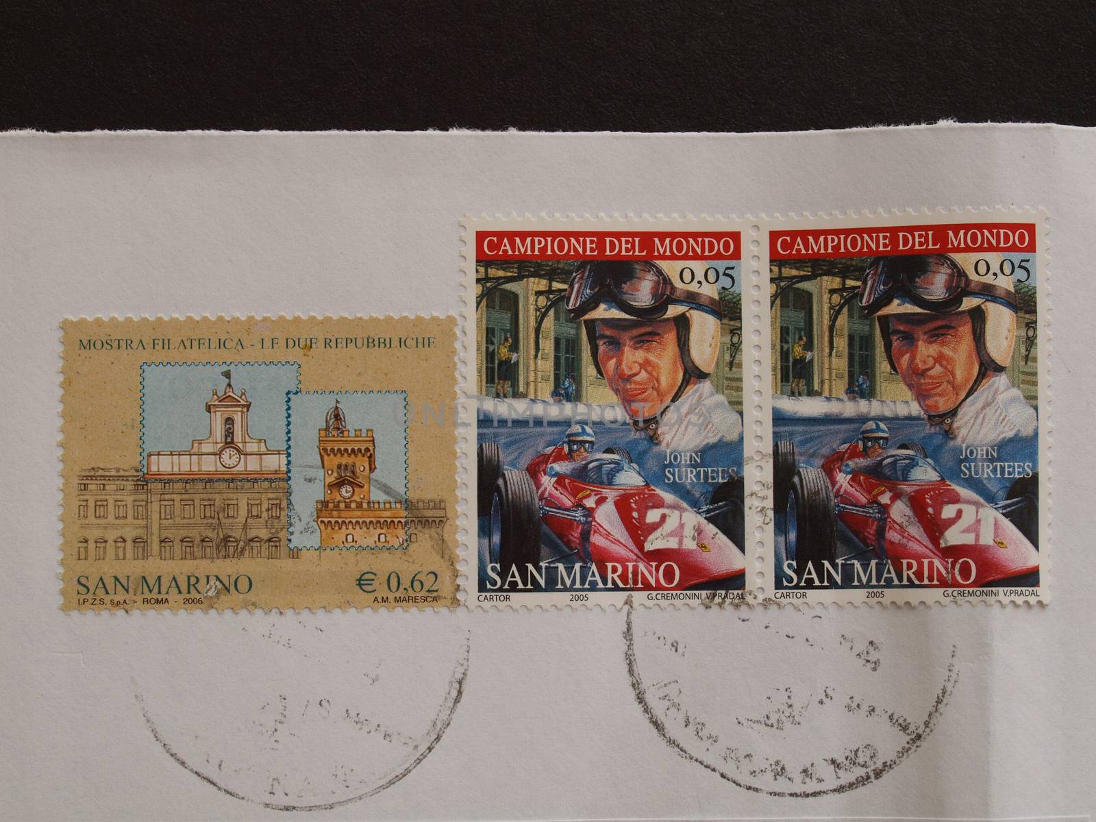 SAN MARINO - CIRCA JULY 2014: Postage stamps printed in San Marino show relationships between Itzaly and San Marino (Le due repubbliche, the two republics) and John Surtees world car race champion