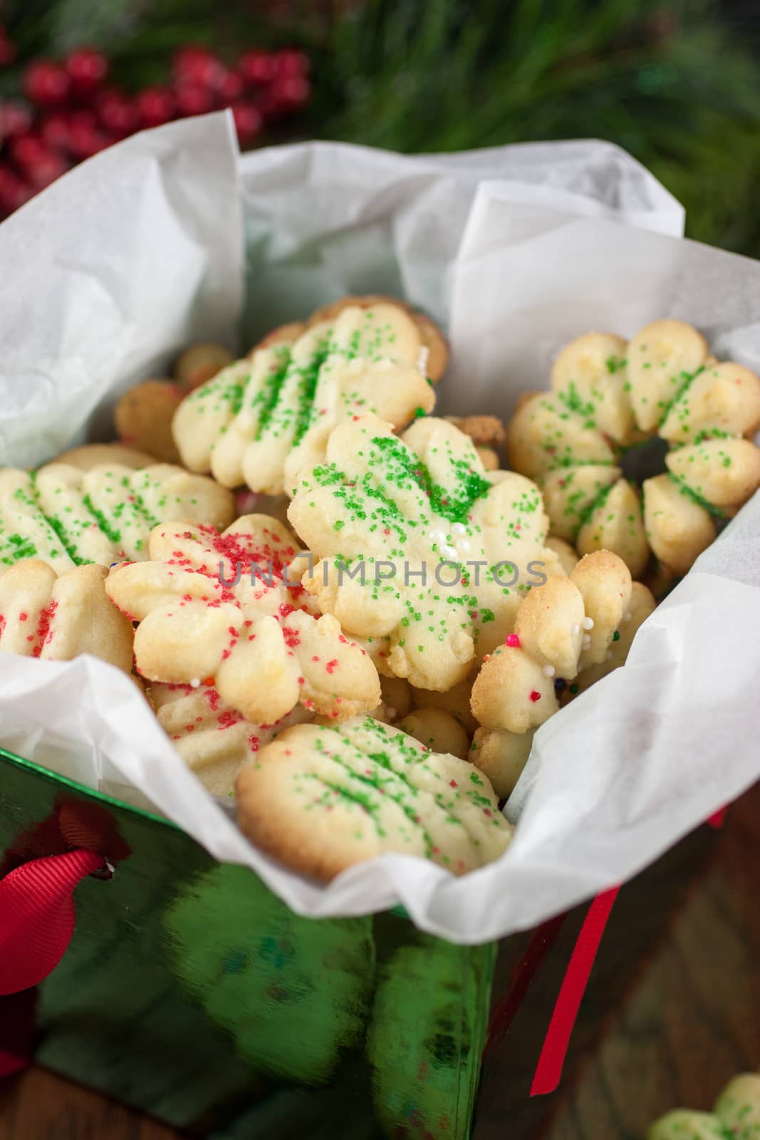 Christmas cookies in a decrative box, sitting on a table.