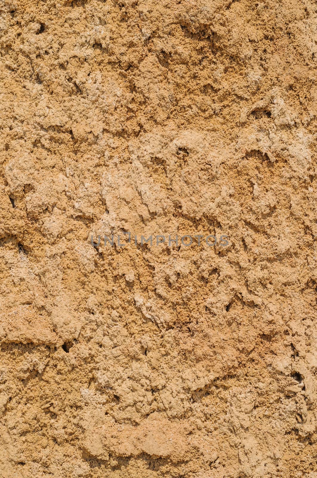 Yellow clay soil texture background, dried cracked surface