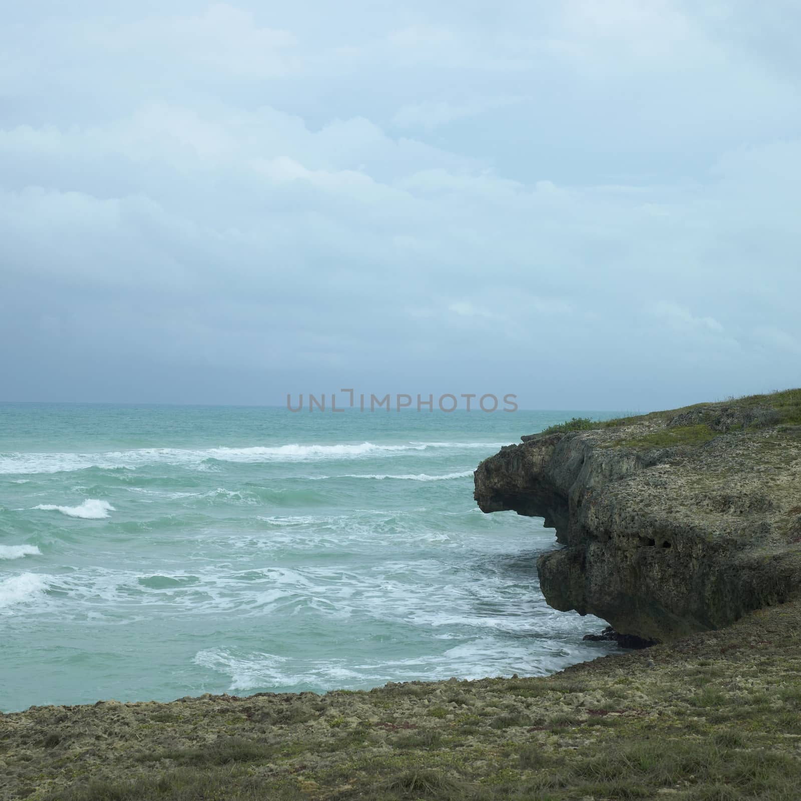 Edge of a cliff with turquoise ocean