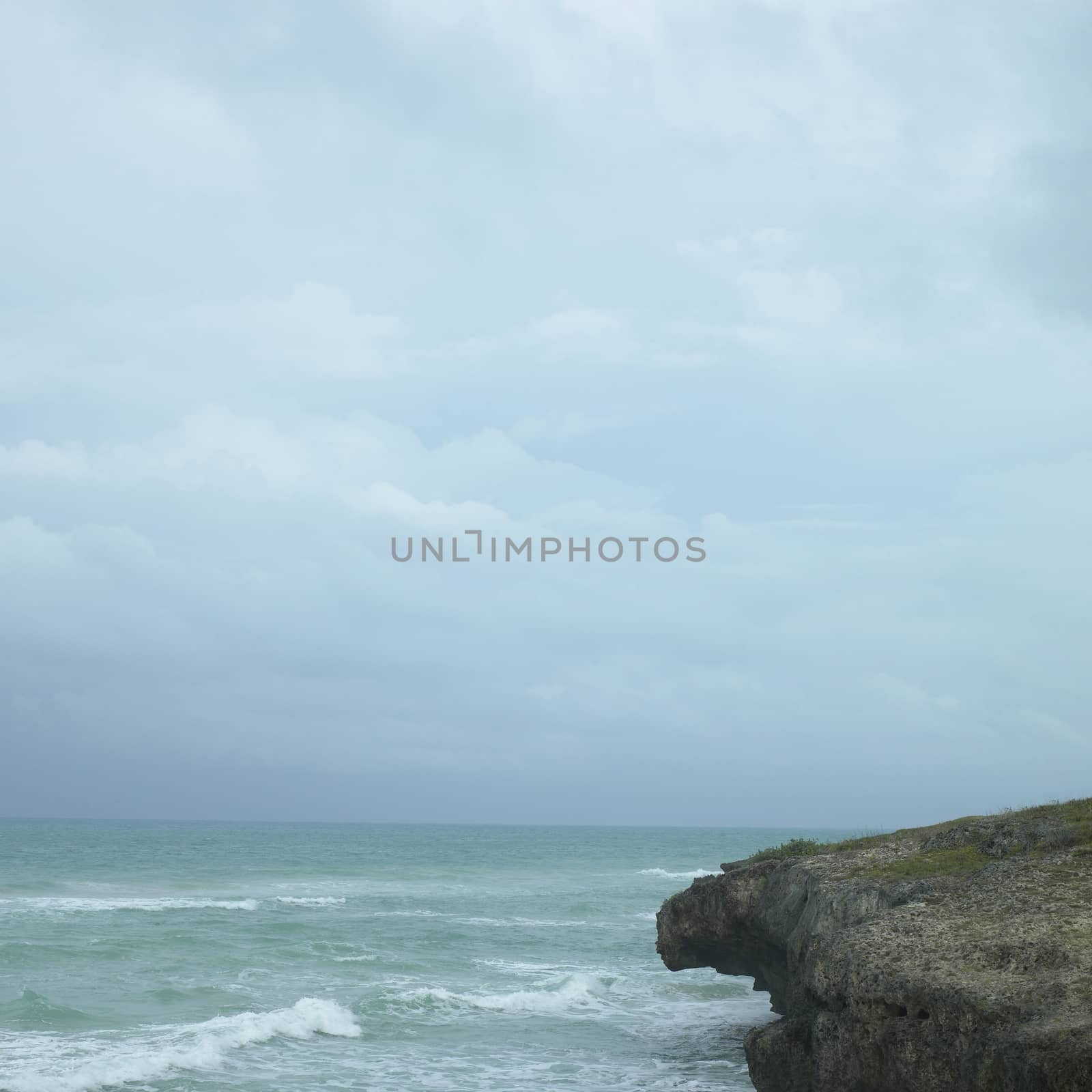 Edge of a cliff with turquoise ocean