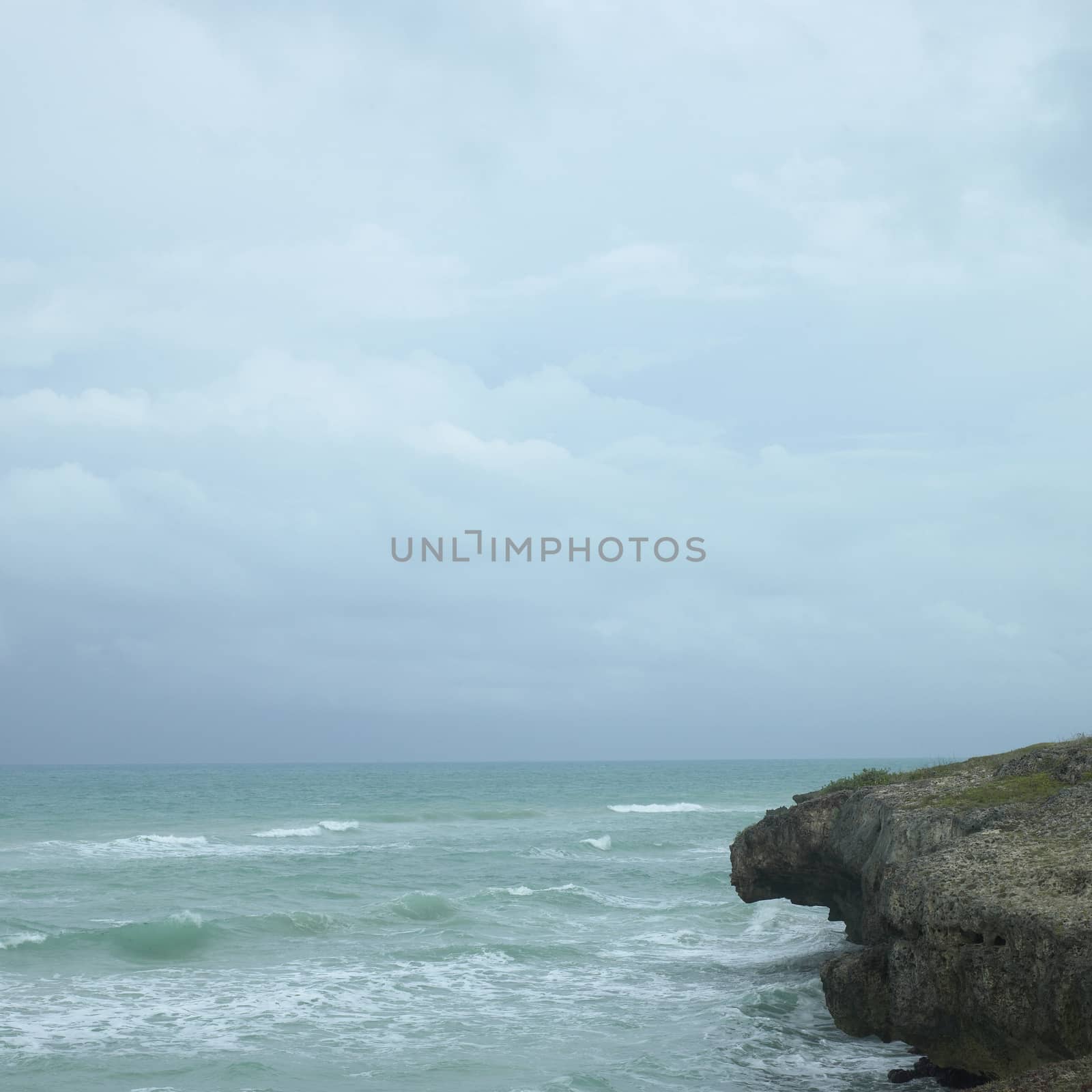 Edge of a cliff with turquoise ocean