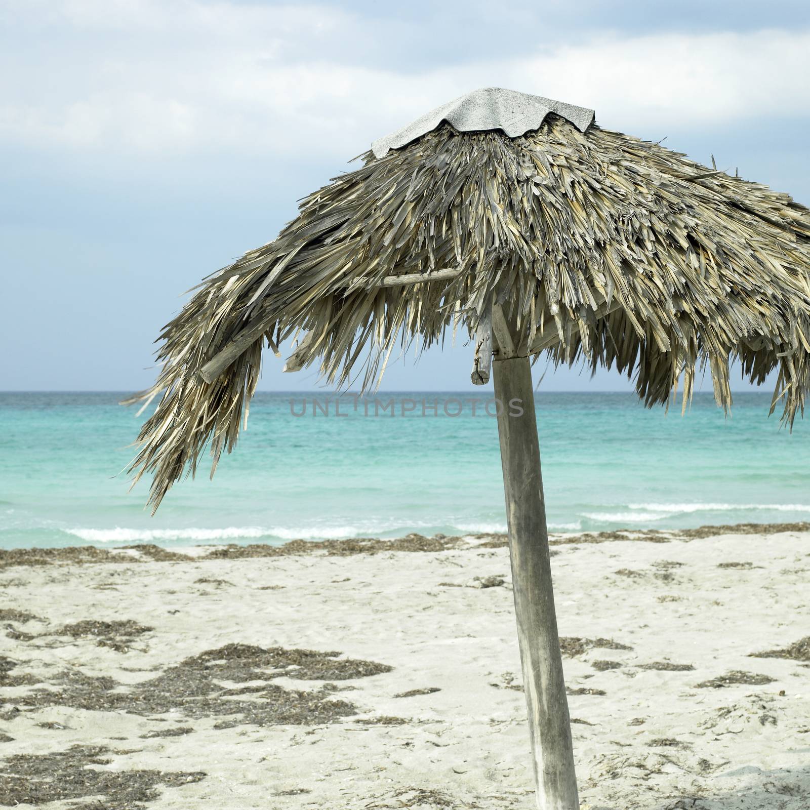 Handmade parasol on an abandonned beach