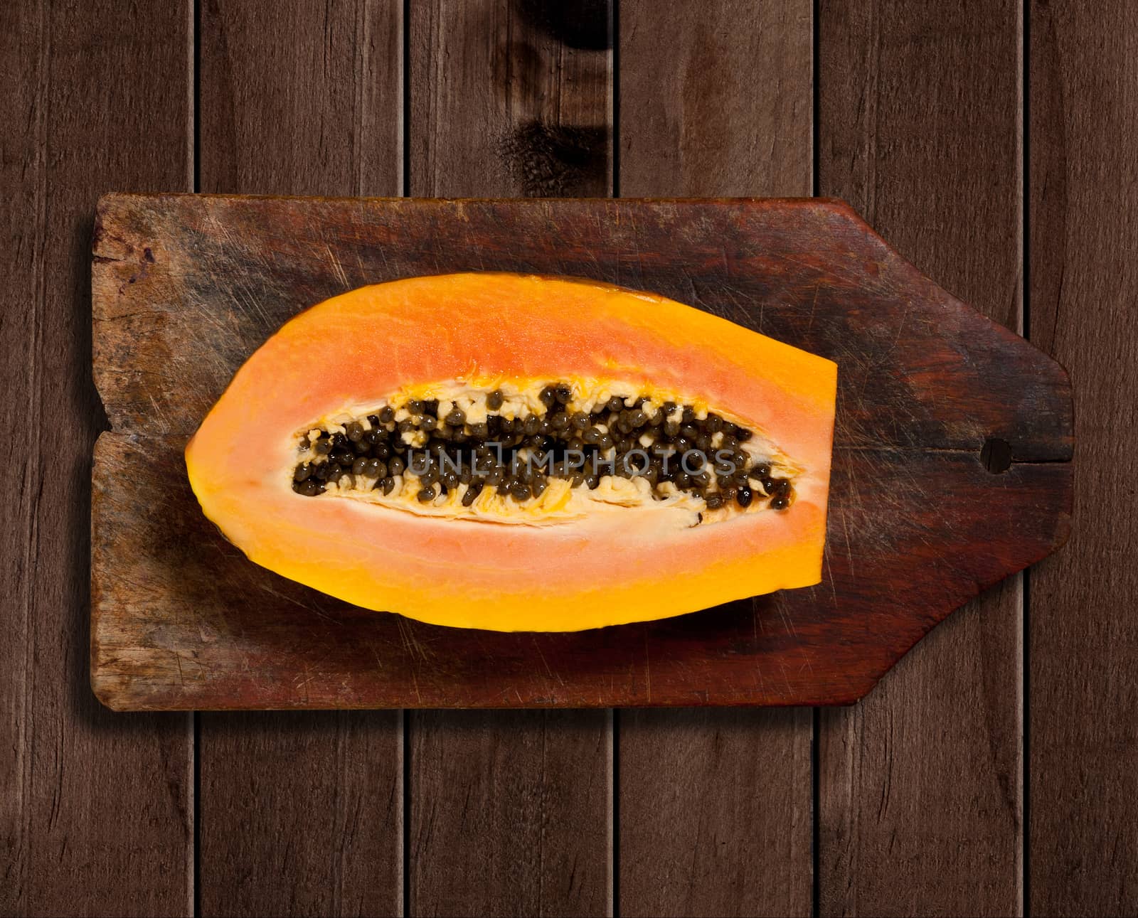 Sliced fresh papaya on wooden table. 