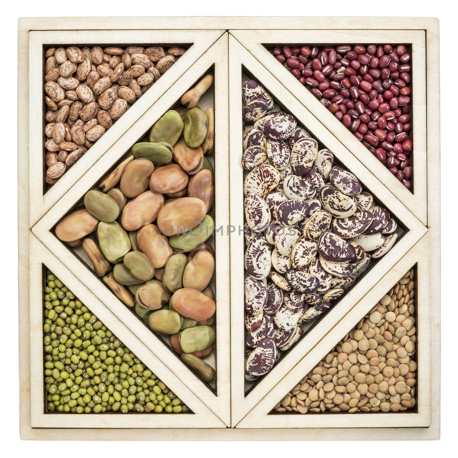 a variety of beans and lentils in an isolated wooden tray inspired by Chinese tangram puzzle