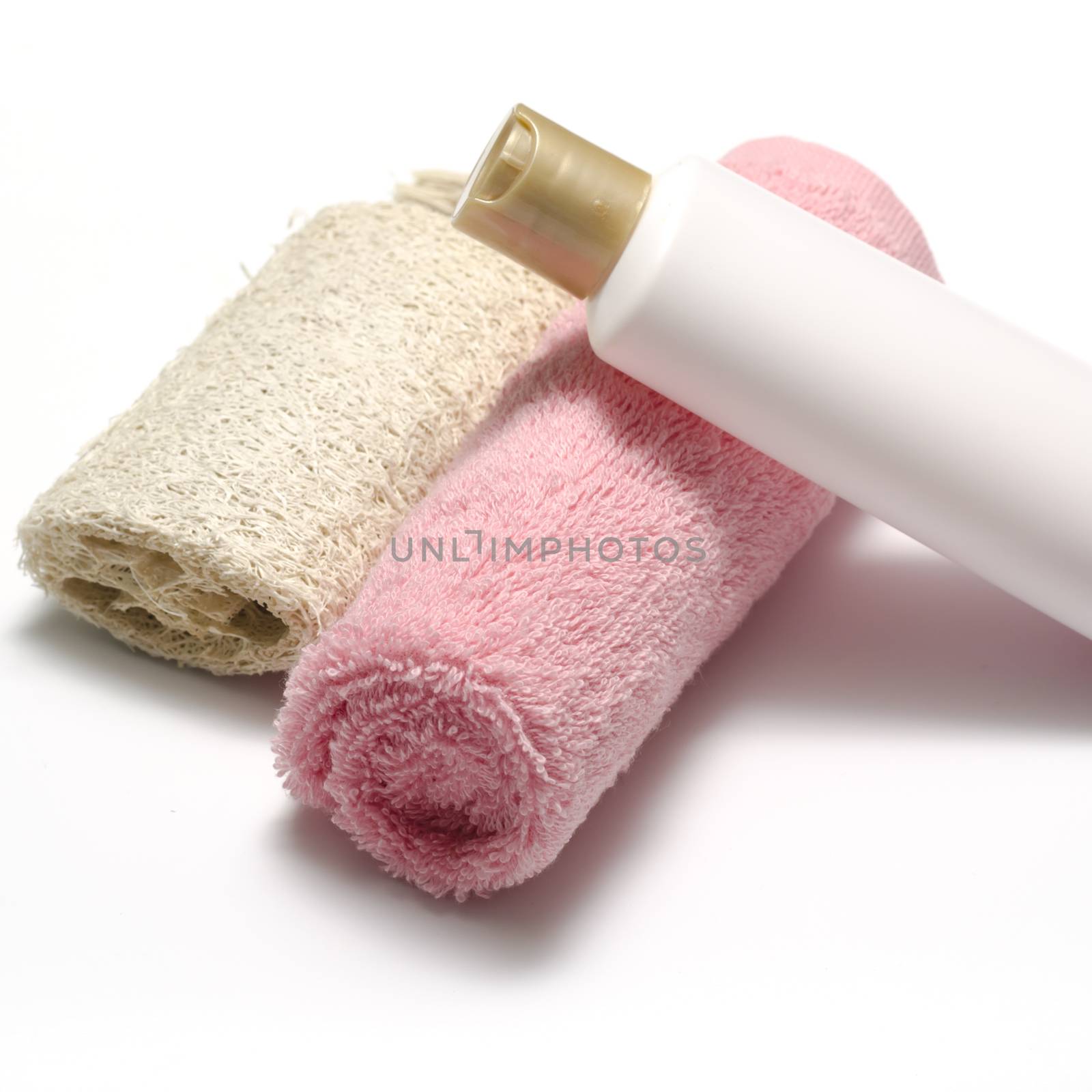 liquid soap loofah and pink towel isolated on a white background