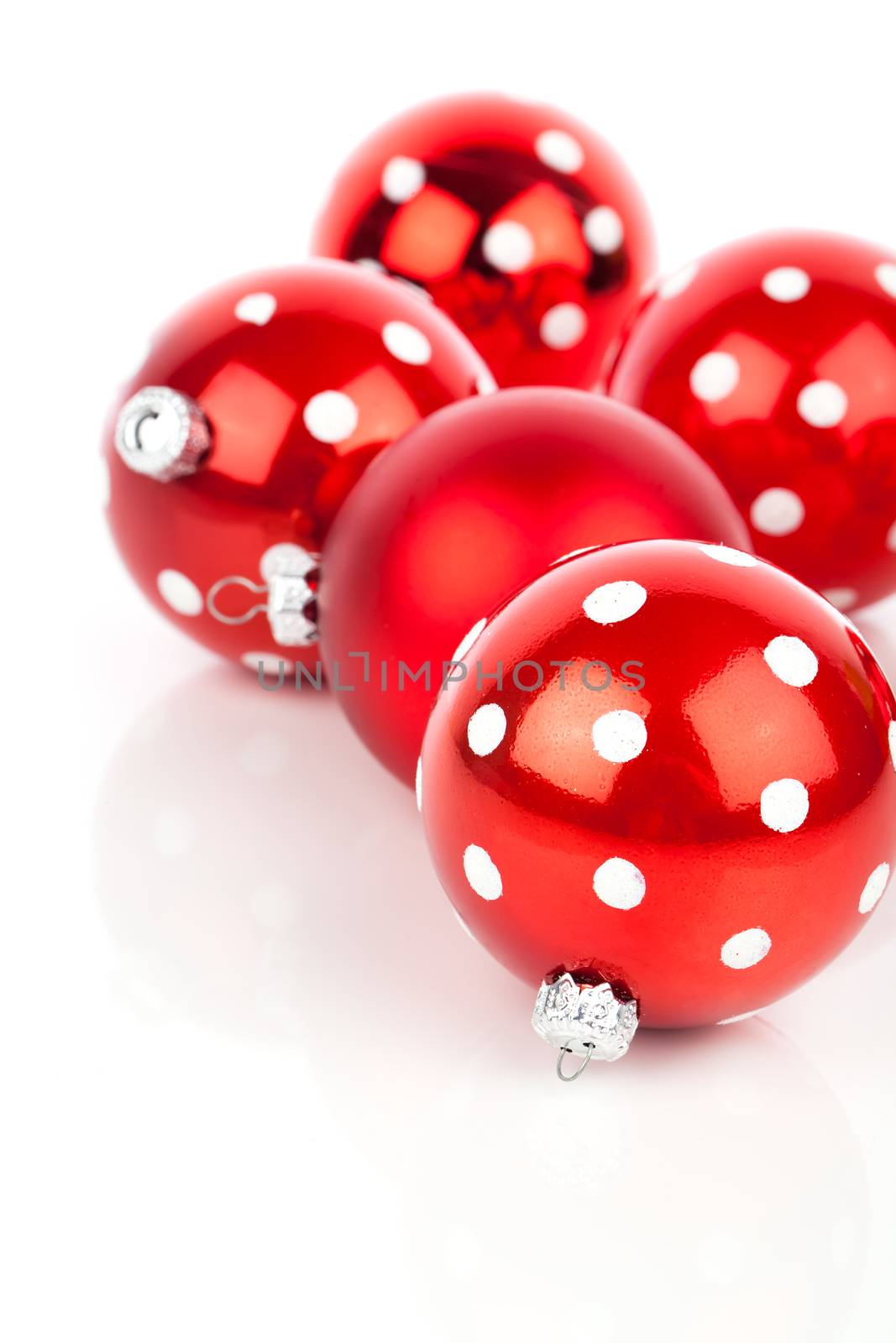 red polka dot Christmas bauble, isolated over white by motorolka